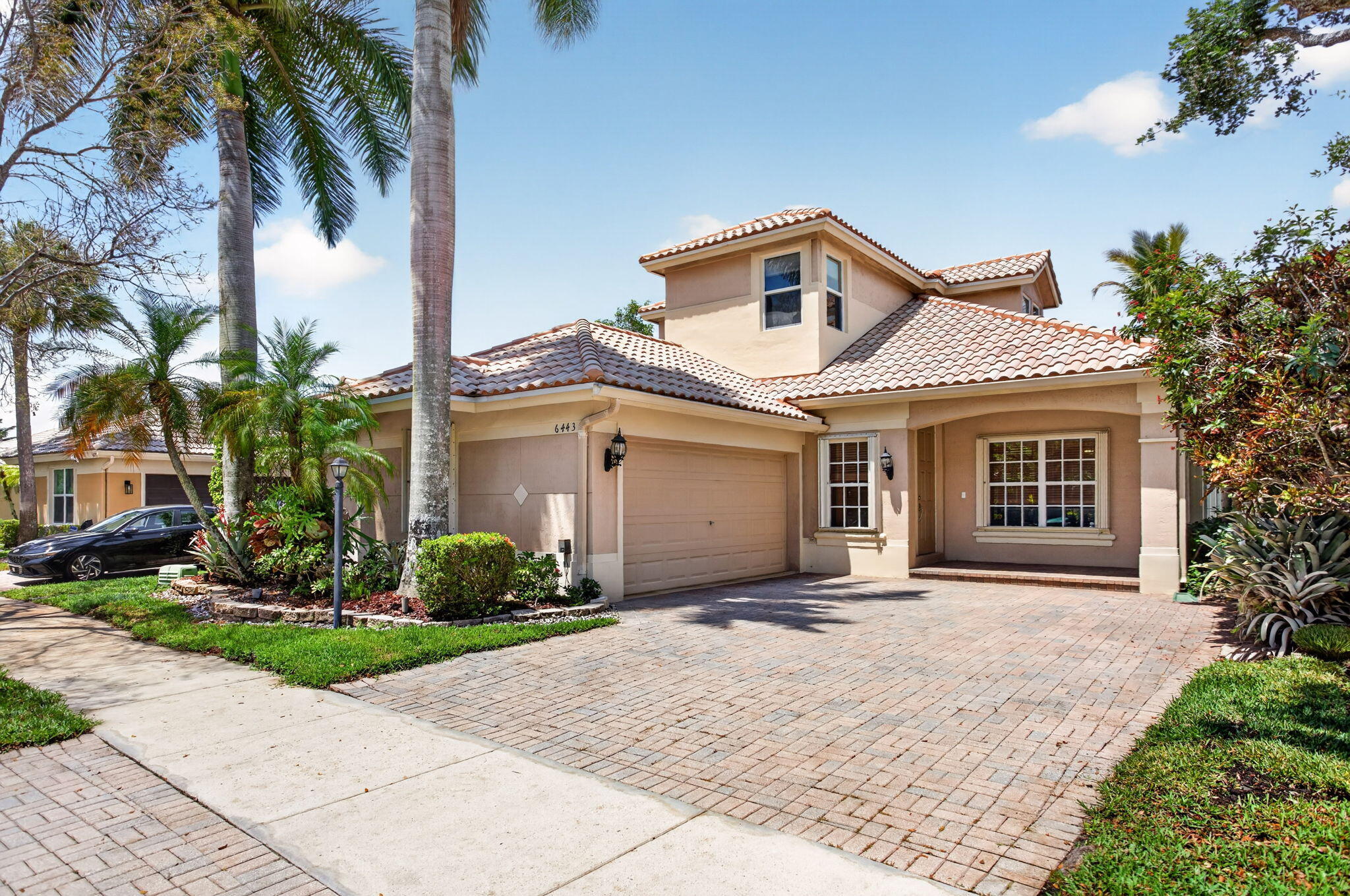 Welcome to this beautifully updated lakefront residence in the highly sought-after community of Parkland Isles where modern upgrades meet timeless comfort in a serene, resort-style setting. Perfectly positioned to capture tranquil water views, this spacious home offers a thoughtfully designed layout ideal for both everyday living and effortless entertaining. At the center of the home is a stunning, fully renovated kitchen (2023), showcasing a large center island, elegant quartz countertops with a matching backsplash, and crisp white shaker cabinetry complementing the gray island. The eat-in kitchen is bathed in natural light and overlooks the peaceful lake, creating the perfect backdrop for morning coffee or casual dining. The main living areas feature neutral tile flooring, enhancing the  bright and airy feel, while the bedrooms offer warm wood and laminate flooring for added comfort. The expansive first-floor primary suite serves as a private retreat, complete with generous his-and-her walk-in closets, patio access and ample space to unwind, plus a spa-like ensuite bathroom with dual vanities, Jacuzzi tub and separate shower. Upstairs, you'll find a versatile loft area—ideal for a home office, media space, or playroom—along with two additional bedrooms and a beautifully renovated bathroom (2025). Step outside to a large patio where you can relax or entertain while enjoying picturesque lake views and Florida's year-round sunshine. Additional features include a separate laundry room for convenience and a Tesla charger, adding modern functionality for today's lifestyle. Parkland Isles offers 24-hour guard gate, clubhouse, pool & spa, tennis, fitness center and more, all complemented by a low HOA that includes internet and cable. Near A-rated schools, scenic parks, restaurants and entertainment. This home seamlessly blends stylish upgrades, flexible living spaces, and scenic surroundings—offering a rare opportunity to enjoy the best of South Florida living in one of the area's most desirable communities.