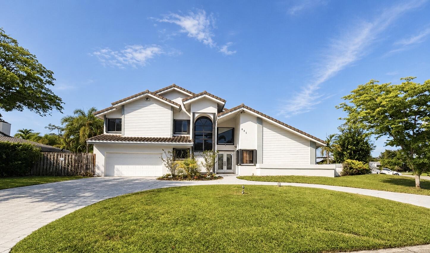 Beautifully maintained two-story home on a quiet cul-de-sac in the desirable Jacaranda area of Plantation with no HOA. Offering approx. 3,200 sq. ft., this 4-bedroom, 3-bath residence features vaulted ceilings, crown molding, granite countertops, and bamboo flooring on the upper level. The oversized primary suite includes a spacious sitting area, private balcony, and pool views. A first-floor bedroom is ideal for guests, an office, or multigenerational living. Enjoy a fenced backyard with pool, covered patio, cabana bath, grill and fruit trees. Additional highlights include a circular driveway, hurricane shutters, dual-zone A/C systems (2017 & 2022), dual water heaters (one 2024), and convenient access to highways, shopping, dining, and parks. This home combines comfort, and functionality.