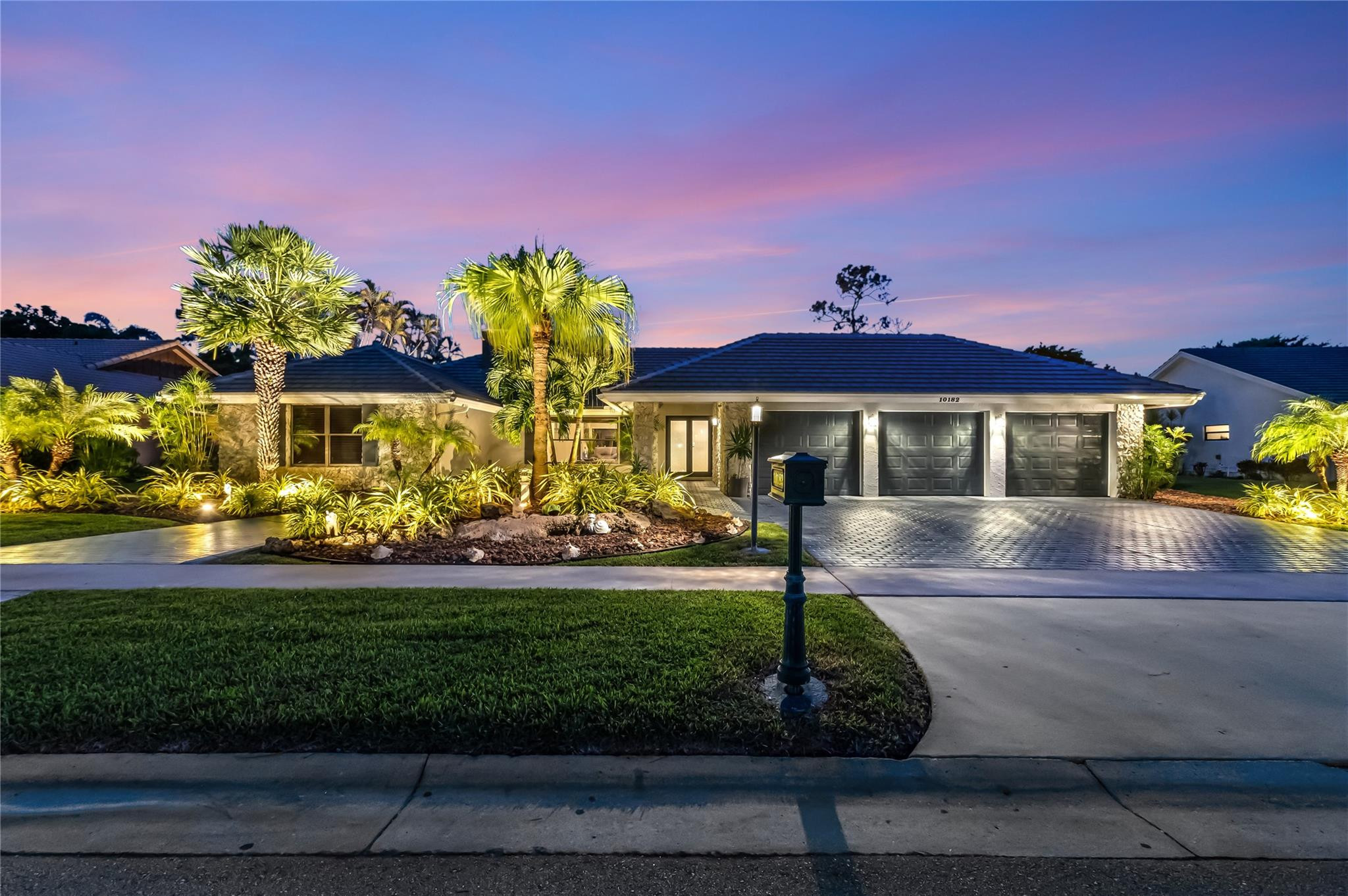 Discover 10182 Boca Woods Ln, a refined estate in Boca Raton's premier country club community. This residence showcases a 2025 roof, natural gas throughout—powering the generator, stove, dryer, hot water, and pool heater—plus a tankless water system, irrigation well, and lush, illuminated landscaping. A circular driveway welcomes you to a 3-car garage and carport for golf cart or tools. Inside, enjoy sleek updates with a modern kitchen, stylish baths, LED lighting, and 4,025 total sq ft designed for comfort and entertaining. Step outside to your private heated pool oasis, then indulge in Boca Woods' lifestyle: 36 holes of championship golf, Har-Tru tennis, pickleball, fitness, spa, and a newly renovated clubhouse with fine dining and vibrant social events