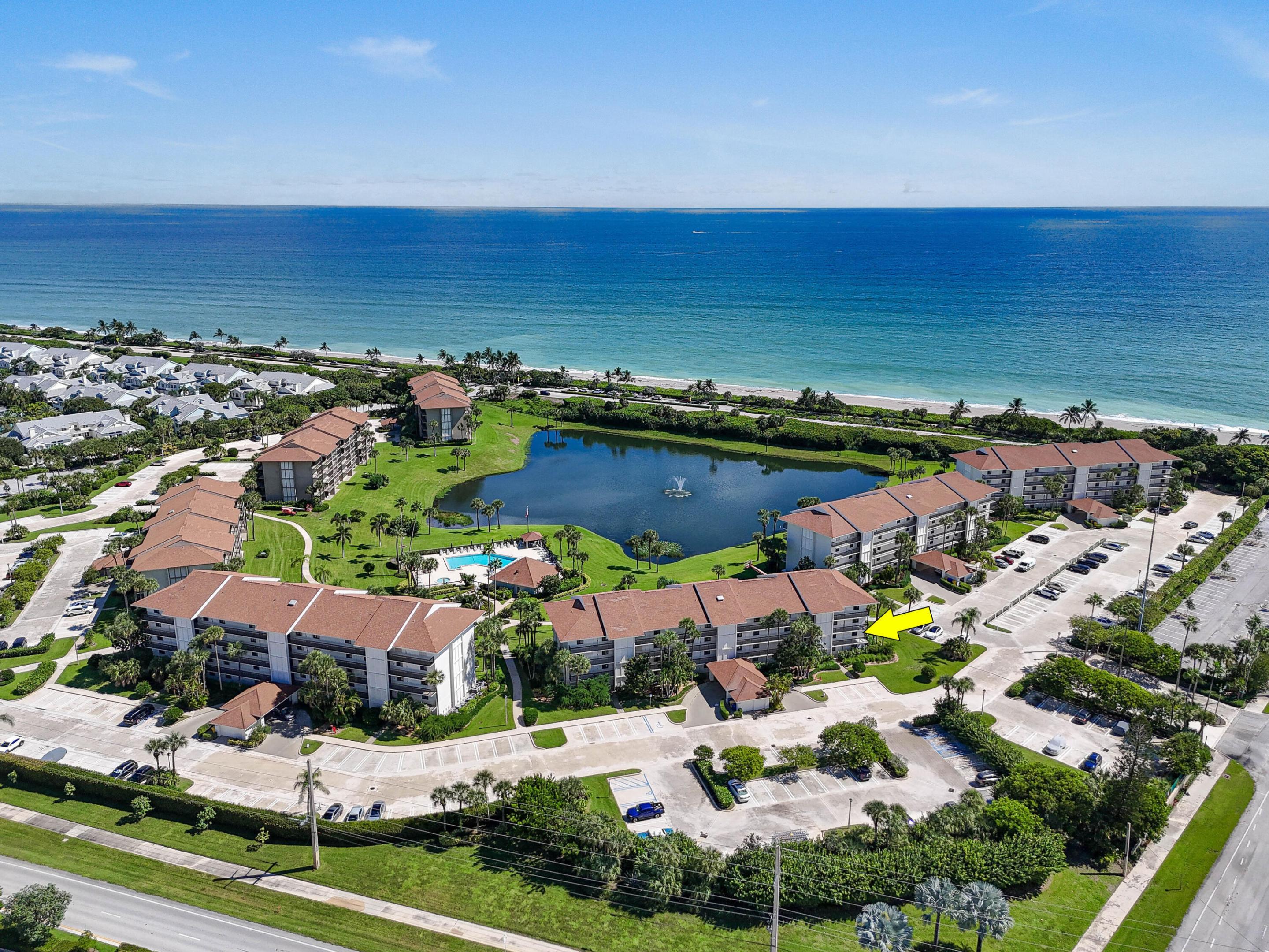 Enjoy the ease of coastal living in this beautifully updated corner residence at The Ocean at the Bluffs South, now offered for rent. Situated in one of the community's most desirable end-unit locations, this light-filled condominium enjoys a coveted southeast exposure with tranquil lake views, refreshing ocean breezes, and abundant natural light throughout. Two private balconies provide the perfect setting for morning coffee, outdoor dining, or simply relaxing while overlooking the lake, pool, and lush tropical landscaping. Inside, the renovated kitchen features custom white cabinetry, quartz countertops, modern hardware, and a premium suite of stainless-steel Bosch appliances. The open-concept living and dining areas are enhanced by expansive sliding glass doors that seamlessly connect the interior to the peaceful outdoor setting. Tile flooring throughout the main living areas and tasteful finishes create a bright, welcoming atmosphere.  The spacious primary suite offers private balcony access, beautiful water views, generous closet space, and an ensuite bath with a large vanity and separate wet area. A comfortable guest bedroom, full guest bath, and a versatile room—ideal for a home office, den, or additional storage—provide flexibility for everyday living.  Additional features include hurricane-impact windows and sliding glass doors, along with a full laundry room complete with a side-by-side washer and dryer and ample storage.  Residents of The Ocean at the Bluffs South enjoy 24-hour gated security, a resort-style pool, tennis courts, and beautifully maintained grounds, all just moments from Jupiter's pristine beaches, Juno Beach, the Juno Pier, premier shopping, and exceptional dining.