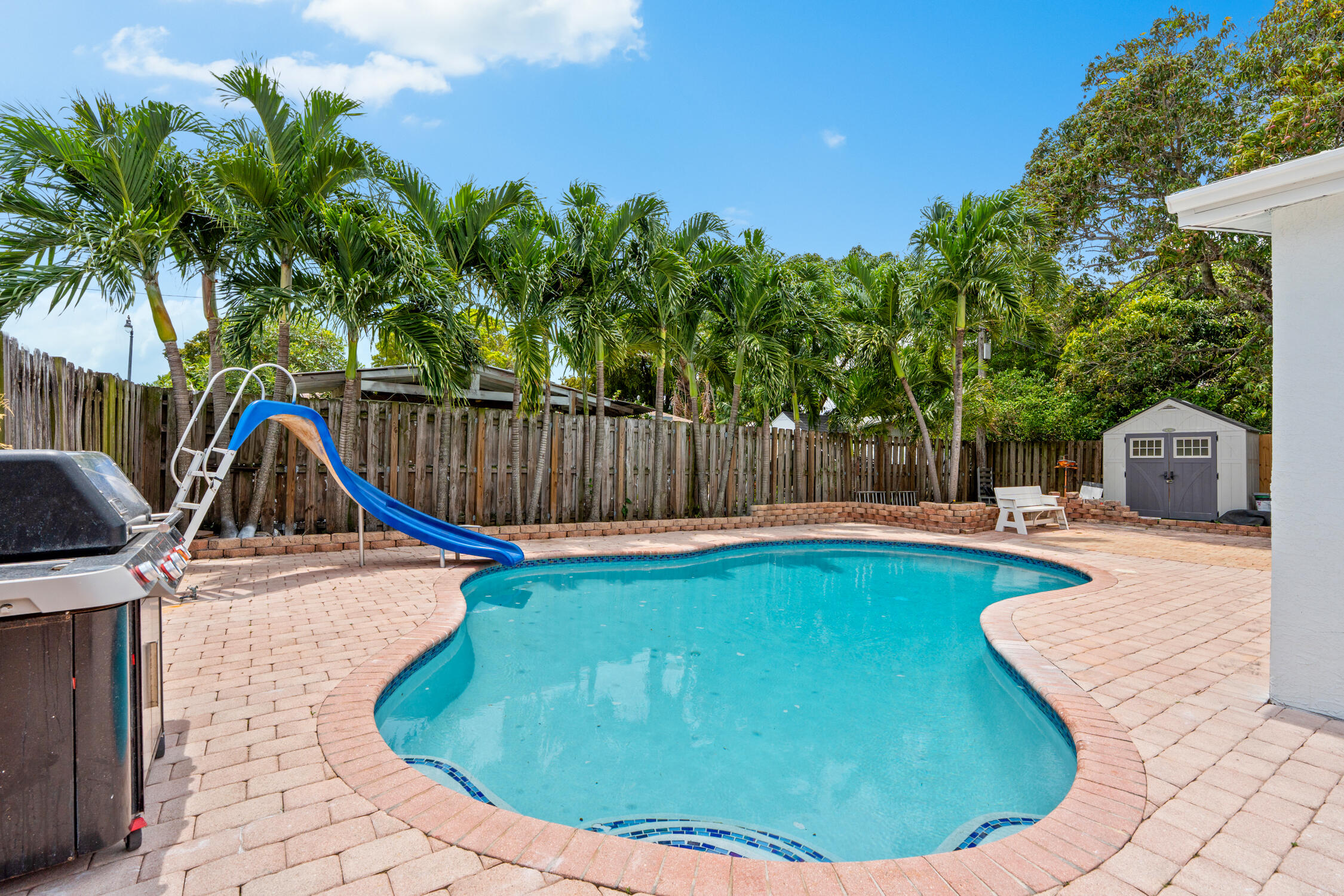 Welcome to your South Florida dream home! This beautifully updated 4bed, 2 bath home offers the perfect blend of comfort, style, and entertainment. Featuring brand-new flooring, a fully renovated kitchen, and updated bathrooms, this move-in ready home has been thoughtfully upgraded throughout. Step outside to your private backyard oasis complete with a sparkling pool and fun water slide, plus an oversized fenced yard perfect for entertaining, The large driveway provides plenty of parking for guests. Conveniently located just a 12 minute drive to the beach and close to popular restaurants, shopping, and major highways, this home offers the ideal balance of lifestyle and location. Whether you're looking for a primary residence, vacation home or great investment opportunity! *Some photos are virtually staged.*