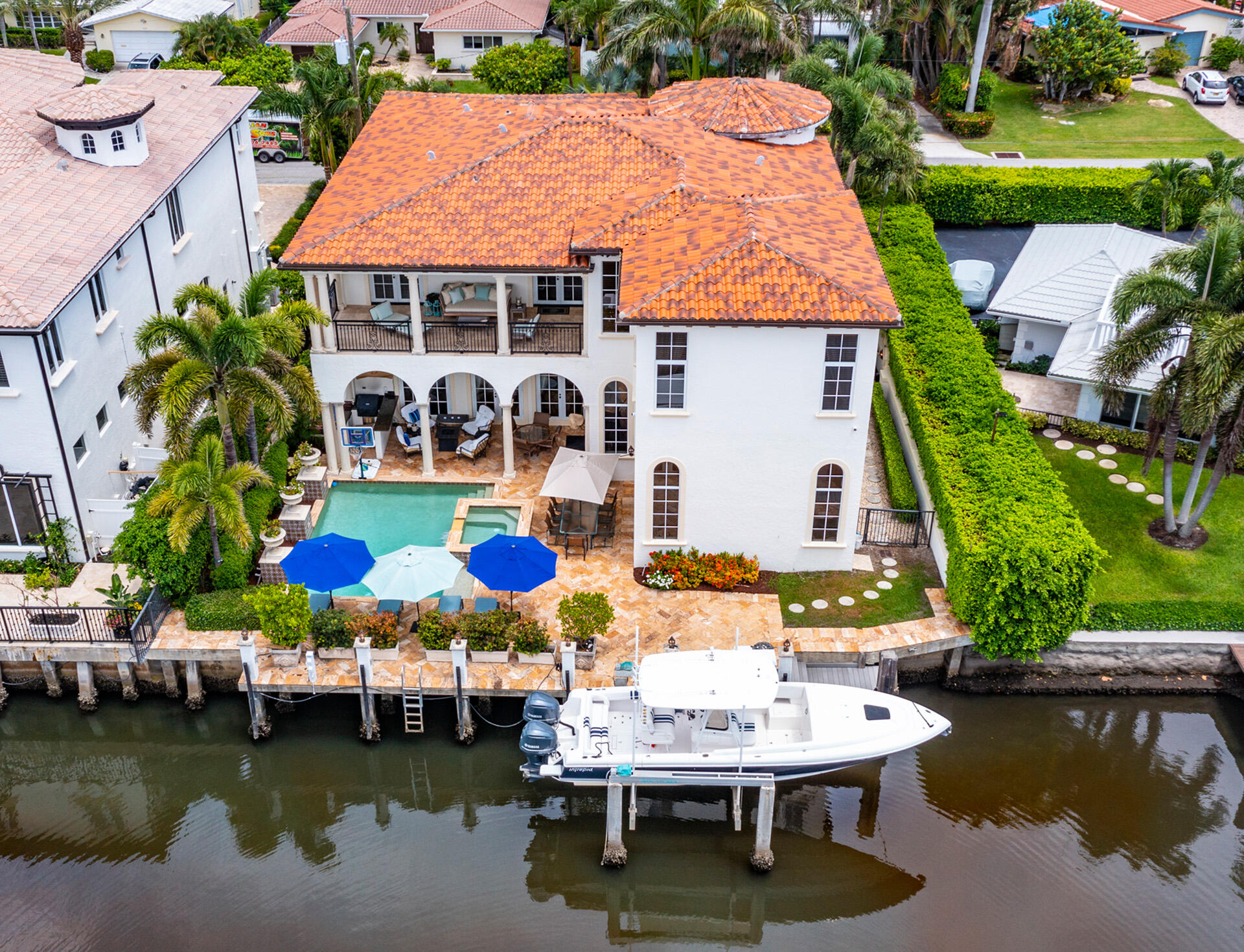 Just steps from the ocean, a highlight of this handsome estate is its prime East Delray Beach location on a beautifully landscaped property with 75 +/- feet along a deep-water finger of the Intracoastal Waterway canal with a dock and boat lift. The lavish residence features luxurious indoor and outdoor living spaces that seamlessly combine to create a striking a balance between elegance, openness and warmth. Master Bedroom Chandelier is excluded. The information herein is deemed reliable and subject to errors, omissions or changes without notice.  The information has been derived from architectural plans or county records. Buyer should verify all measurements. LOCATION

1040 Lewis Cove Road, Delray Beach, Florida: Just off A1A on a cul de sac street in the sought-after Seagate area in East Delray Beach, this waterfront estate is just a few blocks from the prestigious Seagate Beach Club as well as the City's pristine award-winning beaches. This established neighborhood is also just a short drive to Downtown Delray Beach's vibrant Atlantic Avenue, with its array of arts and entertainment offerings interspersed with fine-dining establishments, cafés and bars.

PROPERTY 
 
A brick-paved drive, shaded by Royal Palms, circles around a  tropically landscaped island delivering a beautiful sense of arrival, and in the fenced backyard, a covered loggia, with a summer kitchen and gas grill, overlooks the pool with a spill-over spa. Offering incomparable waterfront living with 75+/- feet along a deep-water finger of the Intracoastal Waterway and running the full length of the property is a concrete  dock with lighted posts and a boat lift that can accommodate a 12,000+/- pound vessel.

RESIDENCE 

Striking the perfect balance between elegance, openness and warmth, this regal five-bedroom Mediterranean-style estate, with 6,812 +/- total square feet, was astutely designed with a well-conceived floor plan maximizing breathtaking water views and a seamless indoor/outdoor flow for grand entertaining. Masterfully crafted decorator details include rich Jerusalem-stone and honey-toned hardwood flooring, custom Venetian plaster finishes, and soaring 12-foot ceilings. Introducing this classic architectural gem is a 24-foot-high turreted foyer, featuring inset onyx, lighted alcoves for art display, and a graceful wrought-iron-embellished stairway. Just beyond, through a columned archway, is the gracious living room, with details that include a beamed ceiling, a gas fireplace with an impressive carved coral-rock mantel, and  two sets of arched French doors that open to the poolside loggia. The dining room, also accessed from the foyer via a wide archway, features a gated wine larder, and off the living room is the pool-view custom-fitted library with an ensuite bathroom that serves as a cabana bath. In a separate pool-view wing, informal living is celebrated. Here, the gourmet kitchen, finished with high-end appliances, custom wood cabinets, granite counters, stone backsplashes, two islands and pantry, serves the breakfast alcove and family room. Upstairs, the master suite and two guest suites open to the water-view balcony. The opulent master suite, featuring wood flooring, beadboard ceiling, and morning bar, includes custom-fitted closets and a spa-inspired granite-embellished bathroom. Two additional ensuite garden-view guest bedrooms, laundry room and three-car garage complete the layout, while fine amenities include an elevator, 12-camera security and Creston systems, full-house generator, and phantom screens.

DISCLAIMER: Information published or otherwise provided by the listing company and its representatives including but not limited to prices, measurements, square footages, lot sizes, calculations, statistics, and videos are deemed reliable but are not guaranteed and are subject to errors, omissions or changes without notice. All such information should be independently verified by any prospective purchaser or seller. Parties should perform their own due diligence to verify such information prior to a sale or listing. Listing company expressly disclaims any warranty or representation regarding such information. Prices published are either list price, sold price, and/or last asking price. The listing company participates in the Multiple Listing Service and IDX. The properties published as listed and sold are not necessarily exclusive to listing company and may be listed or have sold with other members of the Multiple Listing Service. Transactions where listing company represented both buyers and sellers are calculated as two sales. The listing company's marketplace is all of the following: Vero Beach, Town of Orchid, Indian River Shores, Town of Palm Beach, West Palm Beach, Manalapan Beach, Point Manalapan, Hypoluxo Island, Ocean Ridge, Gulf Stream, Delray Beach, Highland Beach, Boca Raton, East Deerfield Beach, Hillsboro Beach, Hillsboro Shores, East Pompano Beach, Lighthouse Point, Sea Ranch Lakes and Fort Lauderdale. Cooperating brokers are advised that in the event of a Buyer default, no commission will be paid to a cooperating Broker on the Deposits retained by the Seller. No commissions are paid to any cooperating broker until title passes or upon actual commencement of a lease. Some affiliations may not be applicable to certain geographic areas. If your property is currently listed with another broker, please disregard any solicitation for services. Copyright 2021 listing company All Rights Reserved