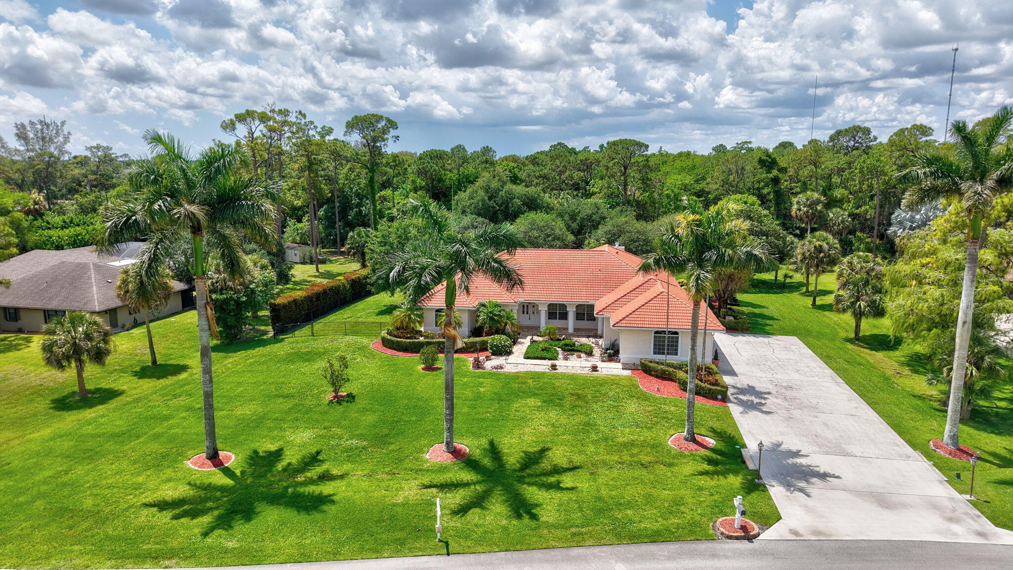 Stunning Estate Home in Sought-After Legend Lakes - Wellington, FL Welcome to 9774 Saddle Court, a beautifully maintained estate home nestled on a private 1.21-acre cul-de-sac lot in the highly desirable Legend Lakes community. Offering 3,084 square feet of thoughtfully designed living space, this 4-bedroom, 3-bathroom single-family residence blends comfort, elegance, and outdoor living at its finest. From the moment you arrive, the property makes a lasting impression with its lush, manicured landscaping and a grand entrance lined with majestic royal palm trees. A charming walkway leads you past a tranquil koi pond, setting the tone for the peaceful retreat that awaits inside.  Step onto the spacious front porch and into a home filled with abundant natural light, thanks to its ideal north-facing orientation and expansive sliding glass doors throughout. ________________________________________   Highlights: • Open-concept layout ideal for entertaining and everyday living  • Elegant tray ceilings in the primary suite and dining room  • Spacious primary bedroom with his-and-hers closets  • Large secondary bedrooms + dedicated office/flex space  • Bright kitchen flowing into the living room • Granite countertops in kitchen and all bathrooms  • Cozy fireplace  • Two A/C units for comfort and efficiency  • 3 car garage with epoxy flooring ________________________________________   Outdoor Living: • Refinished salt-water pool with heater - perfect for year-round enjoyment  • Expansive covered patio and entertaining area  • Built-in grill space  • Backyard backs up to a private wooded area  • Fenced dog yard - perfect for pet owners  • Long, wide driveway with ample parking  • New exterior pathway lighting  ________________________________________   Recent Upgrades & Key Features: • Roof (2023)  • Pool liner (2025)  • Hayward pool cleaner (2024)  • Rain Bird irrigation system (2023)  • Garage water heater (2022)  • Bedroom water heater (2014)  • A/C units (2015 & 2011)  • Two garage door openers (2019)  • Garage epoxy flooring (2008)  • Garage refrigerator (2025)  • Whole-home generator with dedicated electrical panel  ________________________________________ This meticulously cared-for home offers a rare combination of privacy, upgrades, space, and location in one of Wellington's most desirable communities. Schedule your private showing today and experience everything this exceptional property has to offer!
