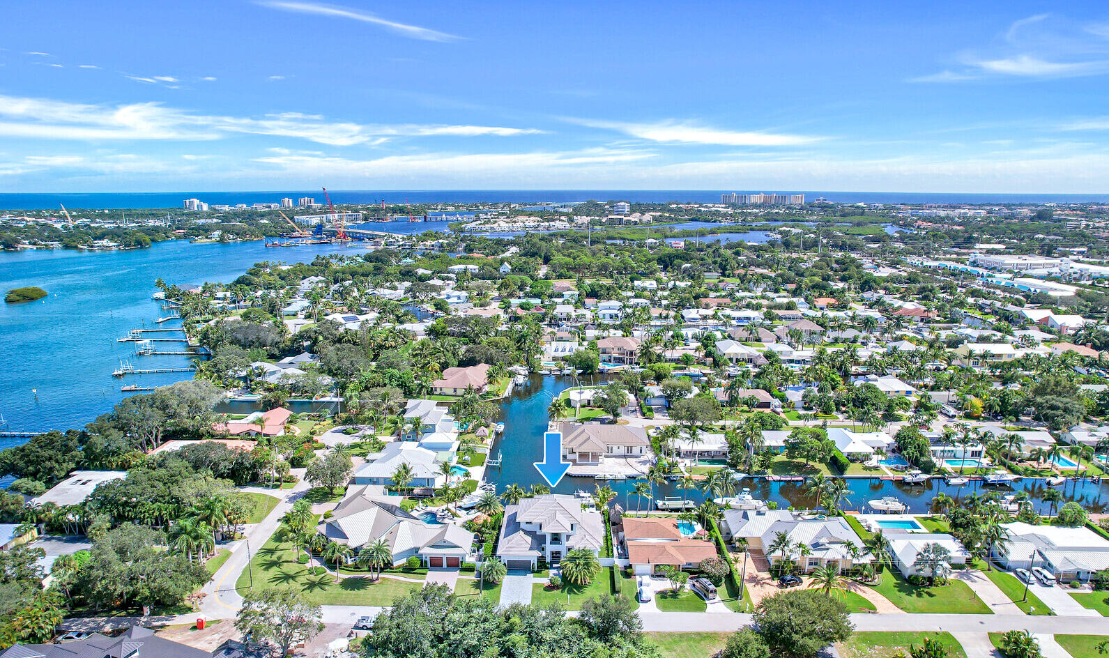 Welcome to paradise with this brand new, coastal contemporary waterfront home located on a deep-water canal with easy ocean access. Park your boat behind this 2-story house that boasts long, expansive water views with 85' of waterfront and a private 65' dock with a 12,000 lb. hi-tide boat lift. Featuring concrete construction & impact windows and doors throughout, this sprawling 3,450 sqft of living residence was impeccably constructed with the finest design, craftsmanship, and functionality in mind. Enter this 3 bedroom + a loft, 3.5 bath, pool home, and marvel at the soaring ceilings, the oversized window and doors providing an abundance of natural light, the open floor plan, and the gorgeous white European 8' wide oak floors with a steel brushed finish.
Please see additional remarks... No expense spared, additional high-quality features include custom cabinetry throughout by Woodlife Custom Cabinetry, dolomite, porcelain and granite counters, custom closets in every bedroom, Subzero, Wolf, and Cove appliances, central vacuum, bathrooms with custom porcelain & ceramic tile with frameless glass shower enclosures, plantation shutters, designer light fixtures, electronic roller shades, custom sheers on all windows, and much more. 
An entertainer's dream, enjoy this resort-style backyard with water views, a custom-designed heated pool with spa and sun-shelf, a covered patio with a full summer kitchen, a turfed backyard with a fire pit, an outdoor shower, and lush tropical landscaping. Other highlights include an oversized 2-car garage, 2 attic storage spaces, concrete slate color pavers on the driveway and walkway, cypress wood exterior ceilings, high-end security systems, 2 Navien tankless propane water heaters, 500-gallon underground propane gas tank, a smart house automation electrical system, and more. This no HOA home is conveniently located to great restaurants, shopping, marinas, pristine beaches, and the Jupiter Inlet. Top-rated Palm Beach County school district, close to Roger Dean Stadium, and very accessible to PBI Airport.  This home's furnishings are negotiable with upscale, and coastal contemporary decor.