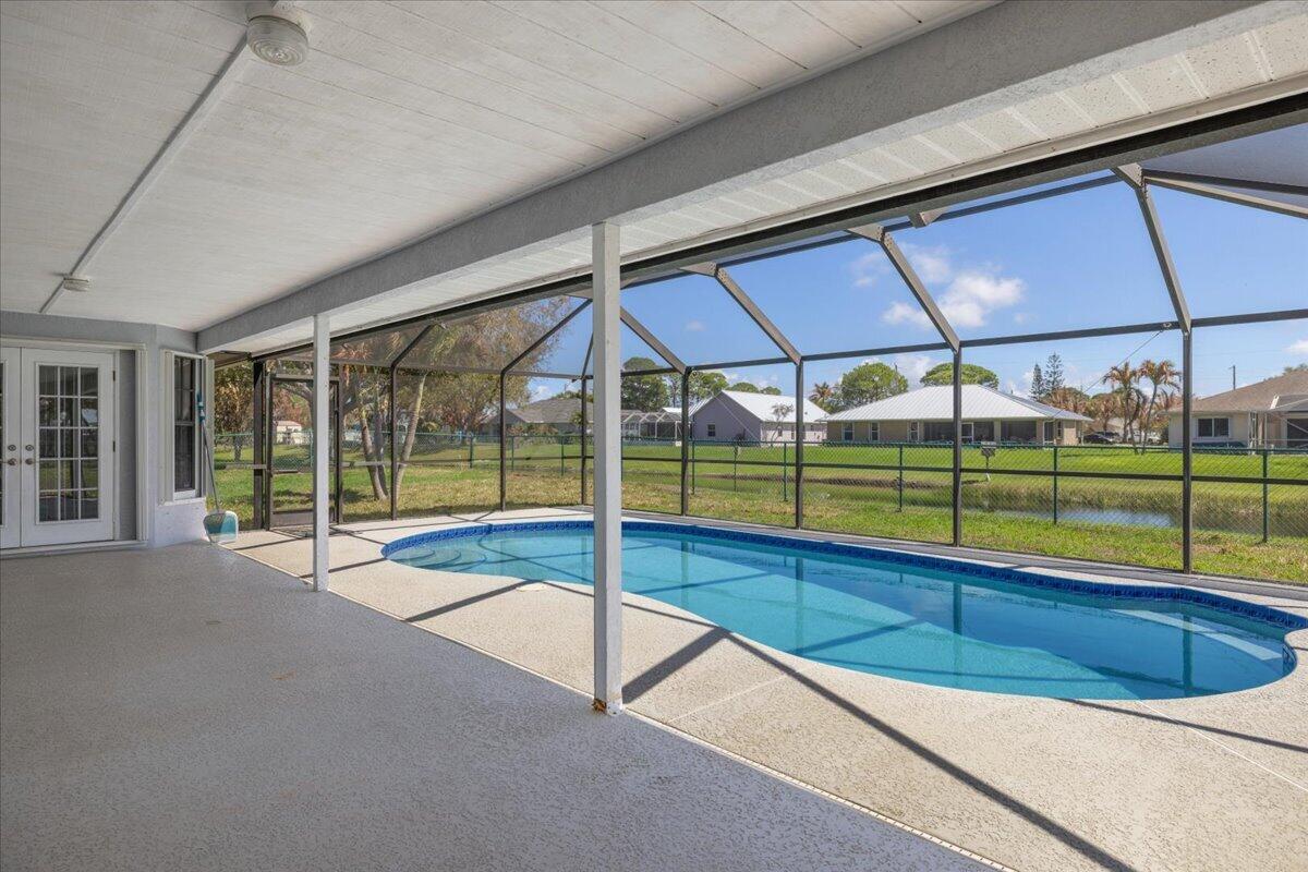 3 bedroom, 2 bathroom pool home with a den and 2,002 sq ft of living space, 2 car garage. Freshly painted interior, new pool pump/timer, 2024 roof, accordian shutters, completely move-in ready! The home features stainless steel appliances, updated kitchen cabinets, an attic fan, rv/boat parking, and a spacious layout with plenty of natural light throughout. Enjoy Florida living at its best with a screened-in pool enclosure and fenced in yard overlooking the peaceful canal. Large driveway. Located close to the river, Jensen Beach, walking trails, and US-1 conveniently near hospitals and shopping.