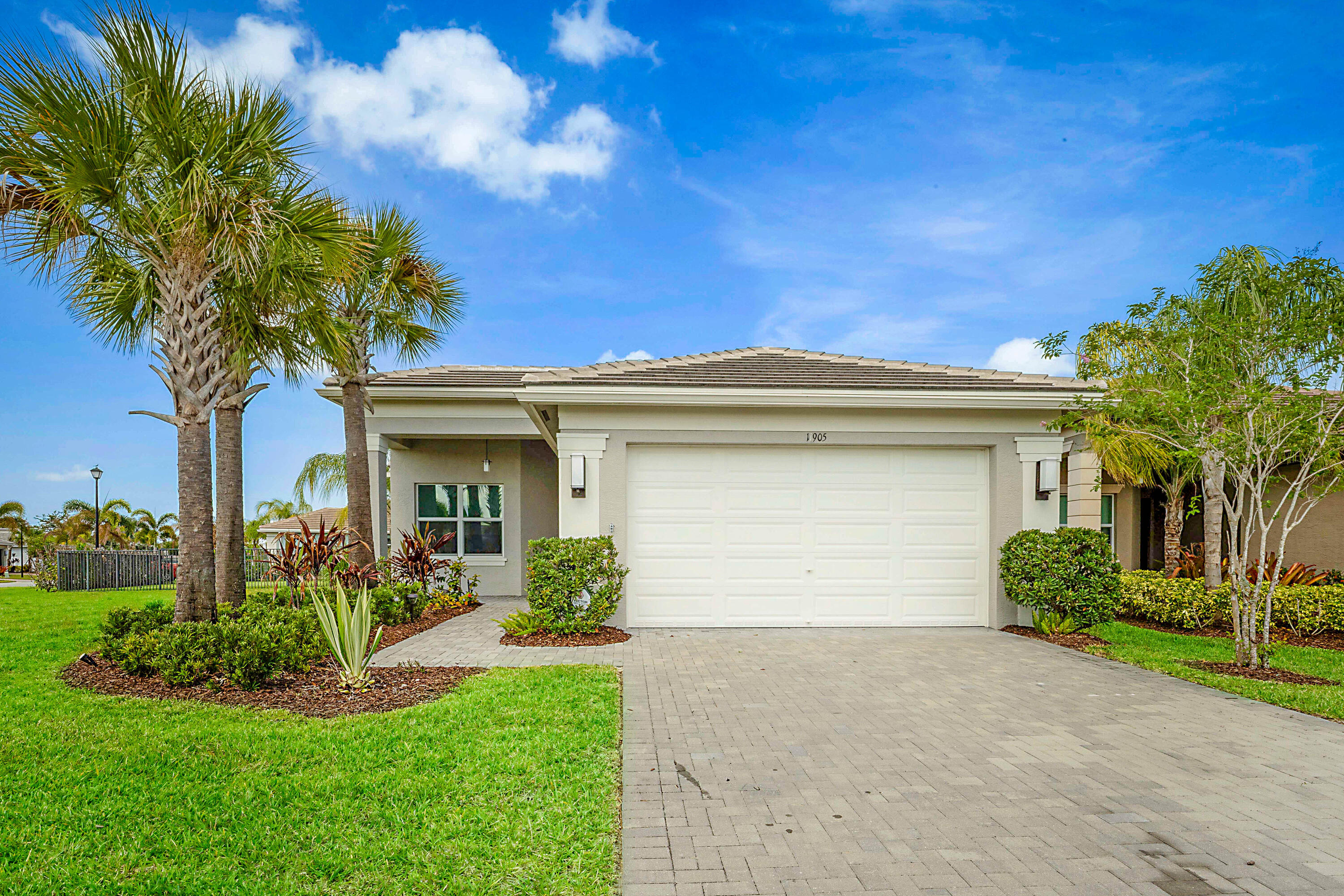 Welcome to 11905 SW Seaway Street in the highly sought-after Valencia Grove at Riverland, a premier 55+ resort-style community in Port St. Lucie. Built in 2022, this beautifully upgraded Sierra model offers 3 bedrooms, 2 bathrooms, and over 2,000 square feet of thoughtfully designed living space on a spacious oversized corner lot. Featuring tile flooring throughout, custom closets, high-hat lighting, and an elegant custom fireplace, this home combines modern luxury with everyday comfort. The gourmet kitchen is a standout with white soft-close cabinetry, granite countertops, upgraded backsplash, custom pantry, GE stainless steel appliances, and a double wall oven. The expansive screened lanai and fenced backyard create the perfect setting for relaxing or entertaining year-round.  Located in the highly sought-after Valencia Grove at Riverland community, this stunning Sierra model at 11905 SW Seaway Street offers the perfect opportunity to enjoy luxury living now — without the 18-month wait to build!   Positioned on a desirable corner lot with added green space, privacy fencing, and lush landscaping, this nearly new residence combines elegant design with exceptional upgrades throughout. Featuring 3 bedrooms, 2 bathrooms, and 2,064 square feet under air, the home is thoughtfully designed for both comfort and entertaining.  The spacious extended screened lanai with oversized screen enclosure creates the ideal indoor-outdoor Florida lifestyle. Inside, the gourmet kitchen is a standout with double ovens, a walk-in added pantry, 42" cabinetry, and upgraded finishes. Additional premium features include a custom fireplace, tile flooring throughout, upgraded overhead lighting, custom closets in both the primary and guest bedrooms, built-in laundry and garage cabinetry, pull-down attic stairs with storage loft access, and a whole-house water filtration system.  This exceptional home offers the perfect blend of luxury, functionality, and convenience — ideal for those seeking an upscale yet comfortable lifestyle in one of Port St. Lucie's premier active adult communities.  Residents of Riverland enjoy world-class resort-style amenities including an onsite café and bar, resort-style pool, card rooms, sports lounge, grand social hall, dog park, and an impressive sports complex featuring tennis, pickleball, bocce, and a state-of-the-art cultural center.
