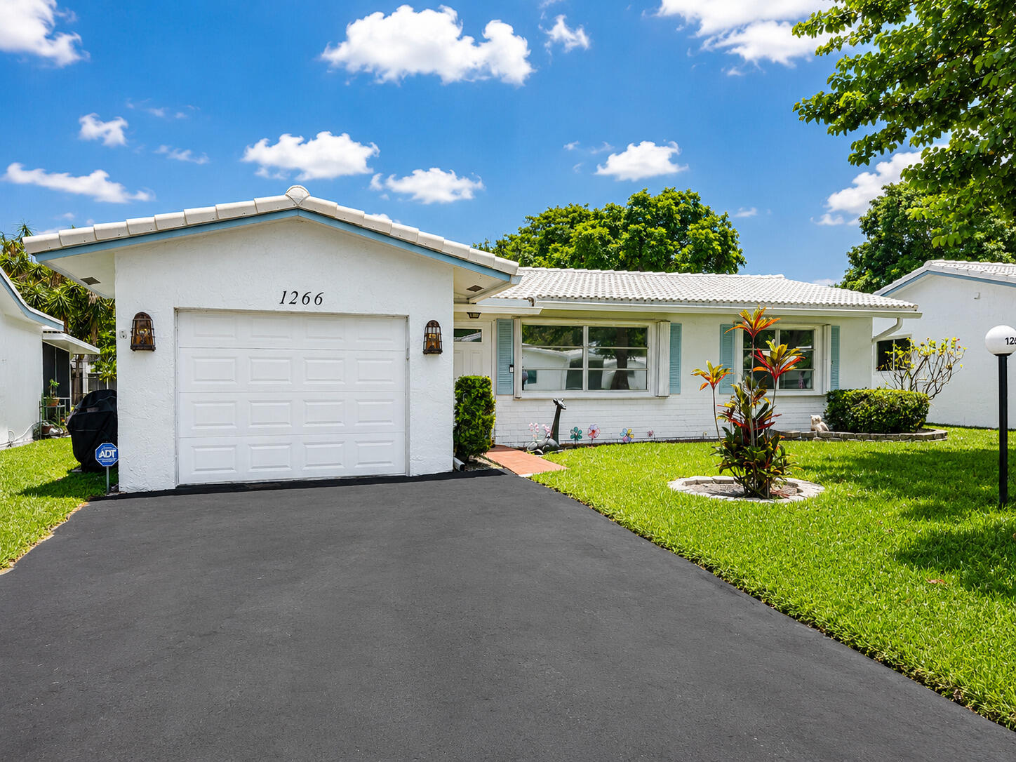 Welcome to this well-maintained Admiral model in the desirable 55+ community of Lauderdale West! This home features a double-wide driveway, one-car garage & a peaceful canal view that opens to the lake. Fresh exterior paint, 2017 roof, full accordion shutters & impact-rated front, side, & garage doors provide exceptional storm protection. The spacious kitchen is a cook's dream with abundant cabinetry, a Lazy Susan, extra-wide drawers & expansive counter space. The air-conditioned garage includes the laundry area with washer & dryer. Enjoy resort-style living with two pools, including a heated saltwater pool, fitness center & live entertainment. Monthly maintenance includes high-speed internet, cable, lawn care, roof maintenance & more! Lovingly maintained & ready for your personal touch!