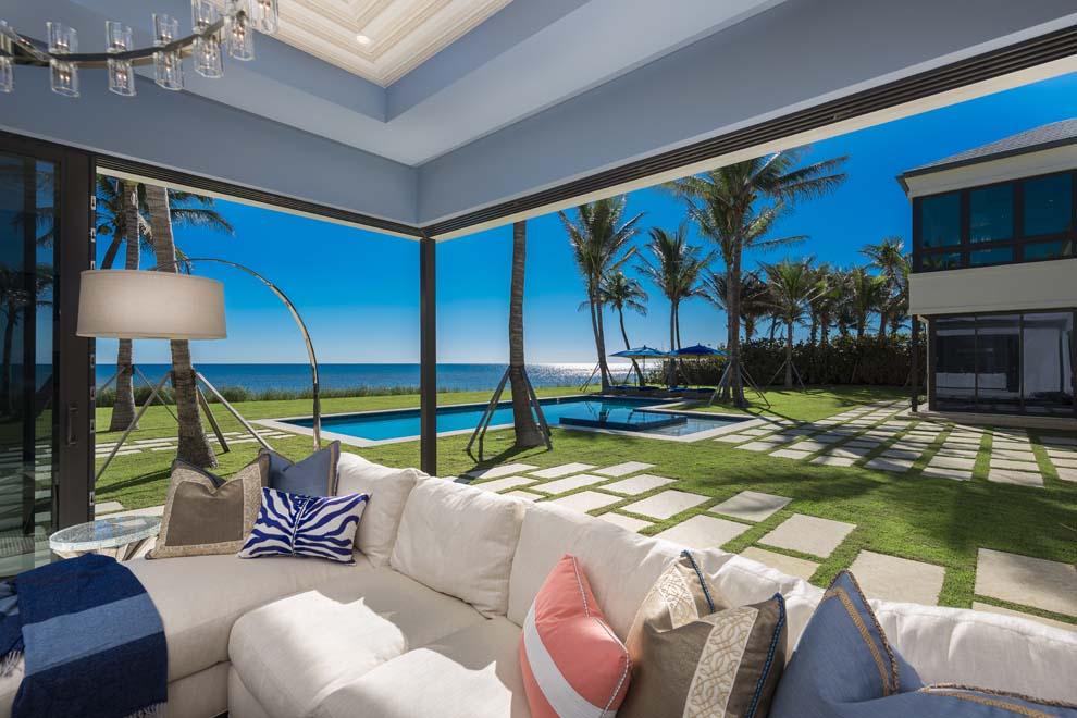 Introducing an exquisitely crafted transitional oceanfront estate with expansive ocean views in the heart of Palm Beach County. Custom built and designed by the most sought-after professionals in South Florida, this entertainer’s dream home features open concept spaces that seamlessly merge to showcase the sophisticated and refined interiors of the indoor-outdoor living residence. Enjoy 158 feet of direct oceanfrontage with a soaring elevation allowing for total privacy and unobstructed views of the Atlantic Ocean. This five-bedroom home offers a luxurious master suite with his-and-her baths and boutique closets plus four en suite guest quarters. This brand new coastal estate represents a rare opportunity to experience the South Florida Lifestyle in the Seaside Town of Ocean Ridge! Welcome to the newly completed oceanfront estate located at 6161 North Ocean Boulevard, Ocean Ridge, Florida. The highest quality craftsmanship and finest finishes are reflected in this custom home built and designed by the award-winning team of Mark Timothy, Affiniti Architects and Marc-Michaels Interior Design. Offered furnished, this entertainer's dream home features open concept spaces that seamlessly merge to showcase the sophisticated and refined interiors of the indoor-outdoor living residence. Situated in the Ocean Ridge Estate Section with 158 feet of direct oceanfrontage, the property enjoys a soaring elevation allowing for total privacy and unobstructed views of the Atlantic Ocean. The Town of Ocean Ridge is perfectly nestled along South Florida's Gold Coast and is conveniently a scenic drive along A1A from the thriving restaurants and boutiques of both Delray Beach and Palm Beach. Travelers will appreciate the three international airports and numerous private airports easily accessible via Interstate 95 or Federal Highway. 

With a prestigious North Ocean Boulevard address, the clean lines of the front wall and pristine landscape combine to create sensational curb appeal. The property is accessed through a gated entry to unveil the stately two story home and manicured grounds. The decorative and expansive drive leads to the front of the home and then to the two separate north and south garages with a large overflow parking just off the main gate entrance. The residence has a unique entry walkway with two ponds on either side and the first glimpse of the grandeur that await through the glass double front doors. With vanishing pocket sliders throughout, the interior and exterior living spaces merge amidst the views of the resort-style pool, five-star grounds and endless ocean vistas. The formal living room is designed to perfection with quality finishes, linear fireplace and a dÃ©cor that captures the seaside elegance. The formal dining room overlooks a charming courtyard and the chic office with floor-to-ceiling glass walls. The chef's kitchen offers every culinary convenience with prep kitchen, butler's pantry, top-of-the-line appliances, snack bar, spacious breakfast area, powder room and sliding glass doors that open to the family room. Enjoy the picturesque views of the ocean thanks to the vanishing pocket sliders that allow the family room to flow to the poolside terrace. The club room was designed for entertaining and enjoyment with a built-in bar and wine cellar at one end and two walls of sliders that open to the covered loggia and seaside grounds on the east end of the room. The first floor en suite guest bedroom with walk-in closet and laundry room with full-size washer and dryer are both located off the northern hallway which leads to the north two-car garage. The white oak floating staircase with glass railings, wood-paneled elevator and powder room are located off the southern hallway which leads to the south two-car garage.

Showcasing stunning views of the ocean and grounds, the second floor grand master wing is a luxurious retreat with a tranquil sitting area; morning bar; access to the seaside balcony; and custom boutique his-and-her closets and baths each with walk-in glass showers and a separate soaking tub in her bath that overlooks the ocean. There are three additional en suite guest bedrooms on the second floor each with walk-in closets and custom, designer bathrooms. The spacious covered seaside balcony has automated screens and can be accessed by the master wing and two of the guest suites. The second floor also has a west-side open balcony that overlooks the grounds; laundry room with full-size washer and dryer; and large storage closet. 

With manicured grounds and abundant green spaces, outdoor living is a breeze. The covered loggia provides ample room for lounging seaside amidst the endless views and can be accessed from the first floor main living areas via sliders that invite the outdoors in. Enjoy endless hours of relaxing and entertaining around the resort-style heated pool with spa complete with seaside terrace, summer kitchen and cabana bath. 

Boasting 13,542 total square feet, this five bedroom residence is complete with all the modern amenities essential for luxury living. Features include white oak wood and limestone tile flooring; designer wall-coverings; impact glass windows and doors; generator; two separate garages with storage; security system; Smart house technology; top-of-the-line appliances; designer plumbing fixtures and more.

This brand new oceanfront estate located at 6161 North Ocean Boulevard, in Ocean Ridge is truly a work of art beautifully displayed amidst the endless ocean views. Offered furnished, this sophisticated residence invites luxury living that is second to none.