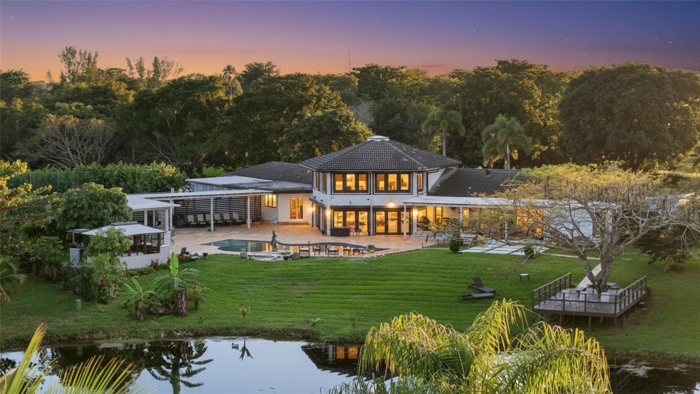 Exclusive private estate on an impressive 1.7 Acre lot in a prime location. This 6-bedroom, 5 bath residence sits up on a hill tucked away on a private cul-de-sac in the prestigious Running Brook Hills of Coral Springs. The spectacular property features its own tennis court, a remodeled pool with travertine deck overlooking a massive lake. The modern open kitchen features a massive 20ft island and integrated fridge and freezer, with hidden butler room/pantry.  The oversized primary suite offers a separate soaking tub, walkthrough shower and a huge walk-in closet. Additional highlights include a dramatic circular great room with soaring 26-foot ceilings, a lofted library, skylights providing abundant natural light, and a large formal dining room. No HOA.