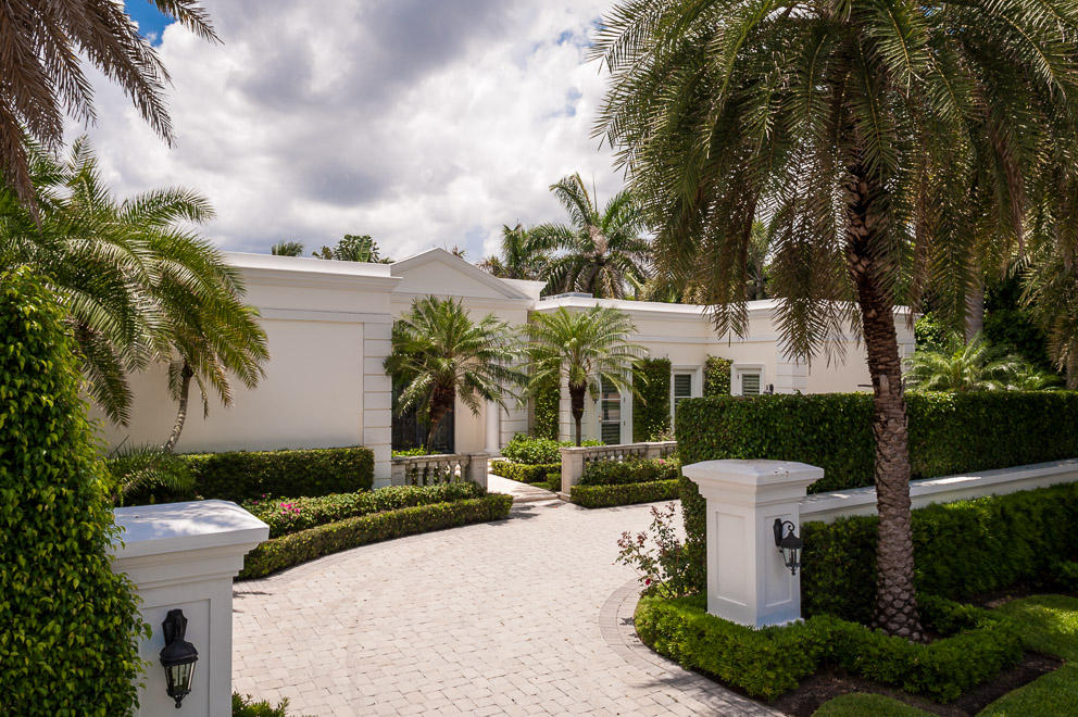 Majestic Regency home, perfect for entertaining, with 10 & 12' ceilings, open, gracious floor plan, looking onto the veranda and pool area.  Meticulously renovated in 2006 to high level, impact windows and doors, marble floors, limestone fireplace, Gourmet kitchen, master suite w/ his and her baths. Large, beautifully landscaped lot, close to the ocean.