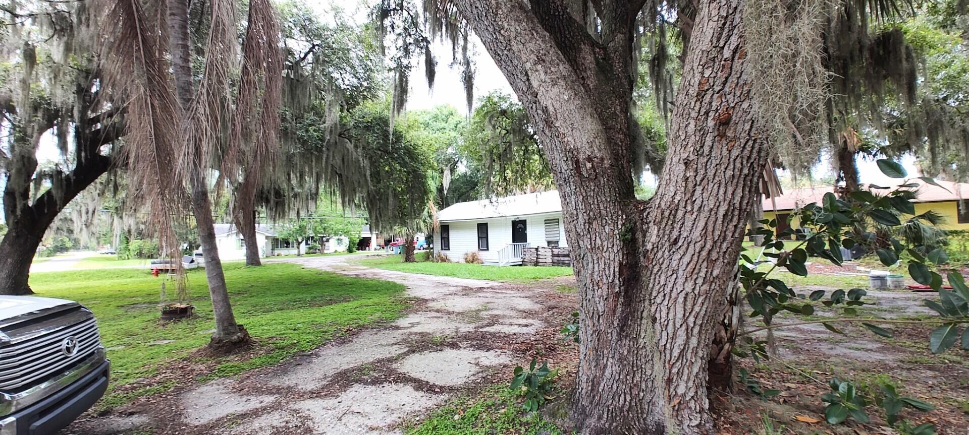 Large, cleared, double lot, with Beautiful, mature Oak trees and swaying Spanish moss nestled in a Historical area near the sought after area of White City. Build your dream home while living in the current Florida Cottage on almost one half acre. 30 year metal roof (2019). Property was mostly upgraded in 2019. Well pump (2018)., This property with its half acre, circular Drive  and Beautiful Oaks could be a Great investment for someone looking to build a new home. Plenty of room for all of your toys. Very Quiet and Country like setting yet close to everything, Grocery, Pharmacy, Fishing, Boating, Shopping, Beaches, Nature Parks, Highways, St. Lucie West, Cinema and more.. No HOA! A Must See!