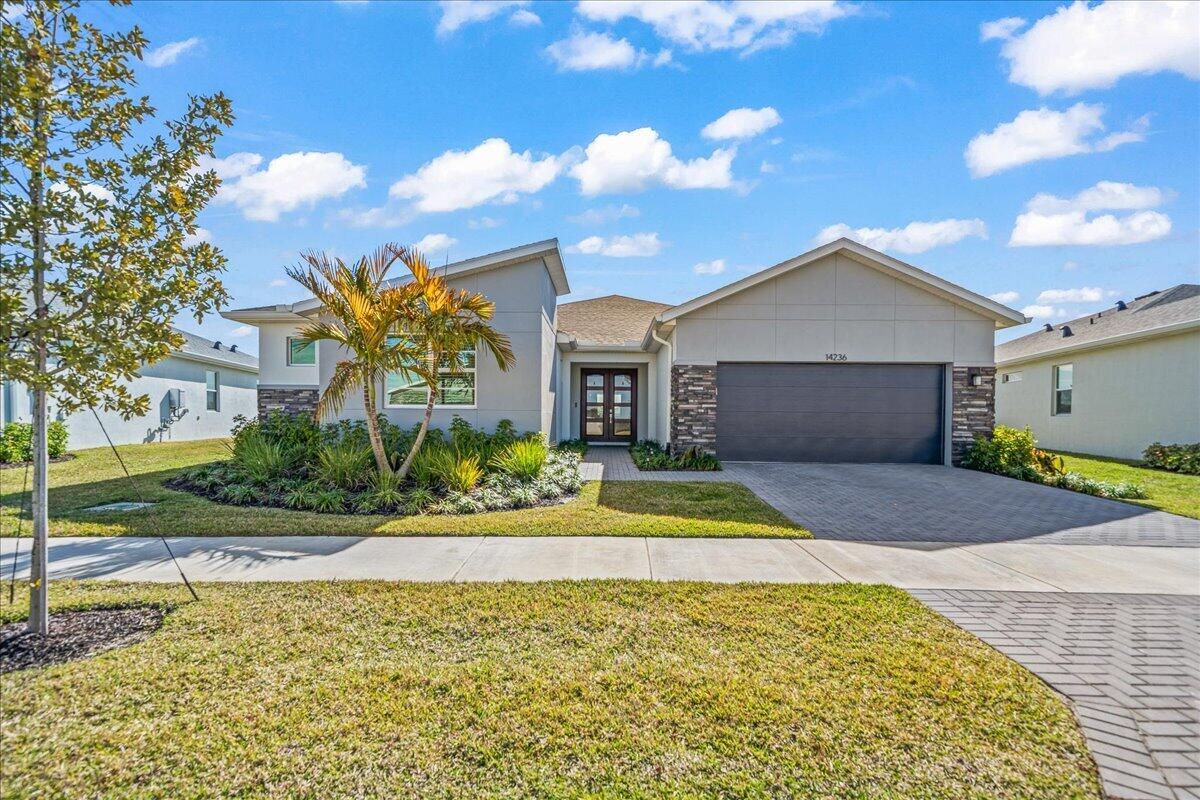OFFERS ENCOURAGED! Why wait to build when you can have like new today? Located in the gated Cadence community of Port St. Lucie, this immaculate 4 bed w/flex room, 2.5 bath Biscayne Bay model is the only one available. Thoughtfully upgraded & truly move-in ready, the home features tile floor throughout, a gorgeous kitchen, paver rear patio, whole house smart system, custom blinds & drapes, brand new custom electric shade for the rear sliders a $2,500 upgrade designed to maximize comfort and waterfront views. Meticulously maintained and spotless, this home offers the rare opportunity to enjoy new construction style without the wait, all in a desirable gated waterfront setting. Tradition offers a unique Florida lifestyle, everything you need is here. Truly maintenance free living.