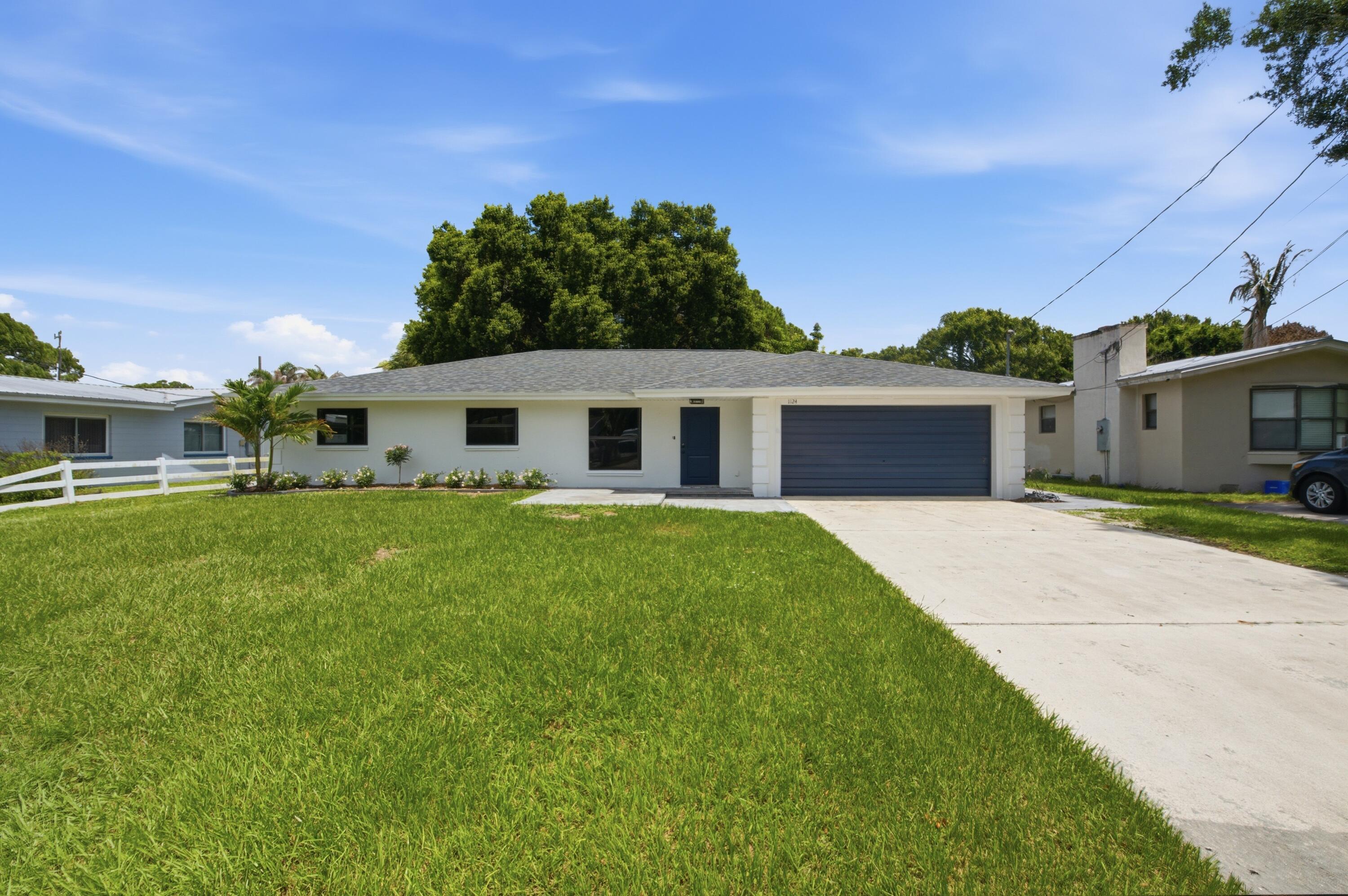 Fully remodeled 3-bedroom, 2-bath home with an attached garage in Fort Pierce. From the roof to the floors, nearly every surface and system has been updated, making this a true like-new product without the new construction price tag.  The exterior features a new roof, new impact windows, fresh exterior paint, updated landscaping, and new concrete pavers on the front and back patios and garage walkway. Inside, new tile flooring runs throughout, complemented by crown molding in the main living areas, wood baseboards, and new interior doors. Both bathrooms have been fully remodeled and the kitchen is brand new — featuring Taj Mahal quartzite countertops and new appliances including refrigerator, stovetop, dishwasher, microwave, and hood. Systems have been addressed as well: upgraded electrical panel breakers, LED flush-mount lighting throughout, modern flush-mount vents, and an AC serviced to new condition. Nothing has been overlooked.  Located in Fort Pierce with convenient access to shopping, dining, beaches, and the Treasure Coast's outdoor attractions.