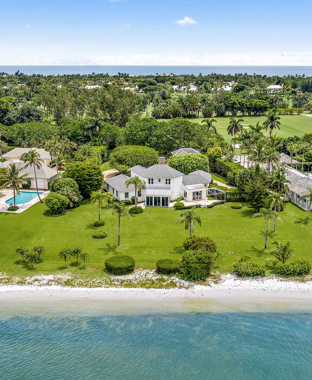 BEST VALUE ON THE INTRACOASTAL ON JUPITER ISLAND! Designed by renowned architect Kemp Caler to ensure that each room would have spectacular Intracoastal views, this wonderful Jupiter Island house and guest house sit on 1.2 acres with panoramic vistas across to nature preserve. The main house with 195' of frontage features 4 guest bedrooms plus a maid's room. There are multiple, expansive entertaining spaces for family or guests including a living room, dining room and loggia. Outside, a large terrace is the perfect spot for watching Intracoastal boat activity and Jupiter Island's spectacular sunsets. The guest cottage has a living room, bedroom and bath plus an efficiency kitchen. If a buyer elects to build a new house to suit his/her needs, regulations allow for a house and guest house of approx. 9000 combined square feet.