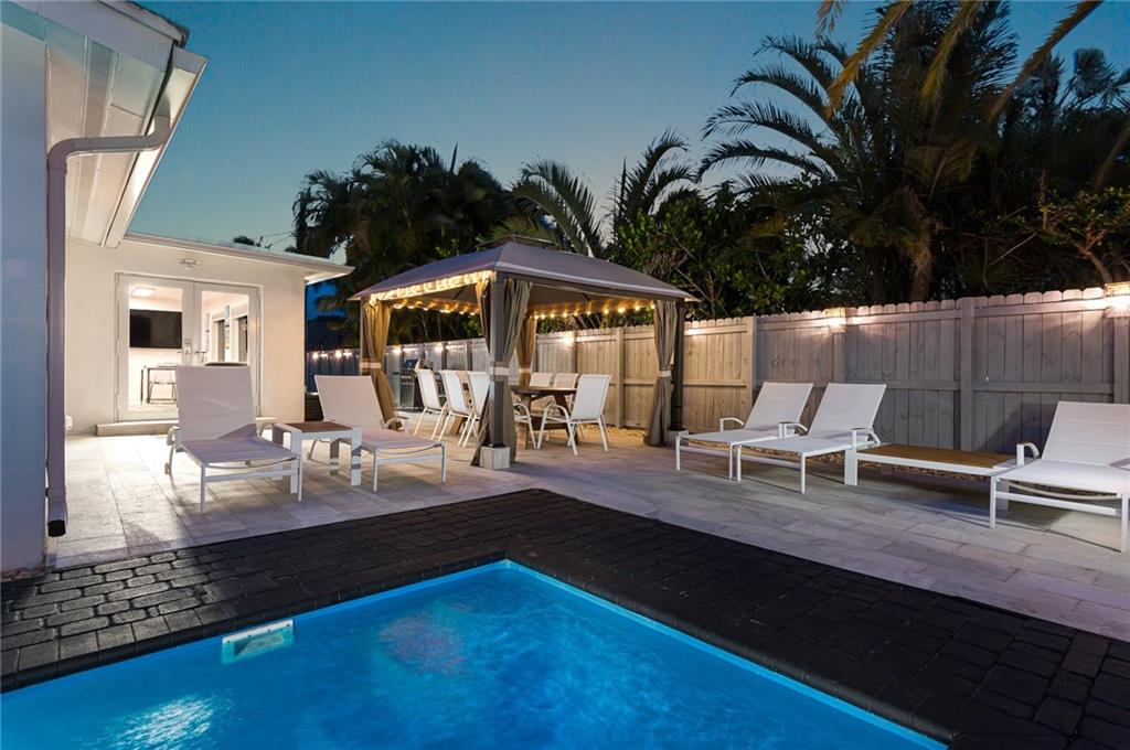 Stunning contemporary renovated home in Conner Estates. All updates are permitted with no expense spared! This pool home boast 3 bedrooms w/en suite baths and a half bath for common areas. Interior remodel includes kitchen and baths, porcelain polished tile in common area and texture porcelain tiles in bedrooms, AC w/all new duct work, impact windows/doors, elec. wiring/panel and all cast iron plumbing replaced. Exterior includes concrete driveway, fencing, landscaping, irrigation, and ext. lighting and new pool/patio w/htr. All done within last two years. Property is currently permitted for short term rentals and is actively being offered as a rental with 5 star rating. Sale price is turnkey including furnishings, fixtures, linens, everything. See supplemental remarks for more details. Indulge in the comfort and serenity of this fully renovated, well-appointed contemporary home. The house offers a tranquil residential vibe in a welcoming and very safe neighborhood. You have quick easy access to the beach, shops and restaurants. Although all looks brand new inside and outside, this house has everything to make you feel at home.The indoor space features an open-concept layout with tasteful furnishings and decor. The living and dining rooms provide plenty of seating on modern sofas or on chairs around the dining table and breakfast nook. Additional seating is provided by the modern bar stools around the kitchen counter. A 70” TV keeps the guests entertained in the common area.The brand new kitchen has granite counters, modern high-gloss cabinetry, all black stainless LG appliances: French door refrigerator with instaview door-in-door, electric range, microwave and dishwasher. It includes garbage disposal, Keurig coffee machine, Cuisinart toaster, Emeril Lagasse 12-quart air fryer, Hamilton Beach food processor and Magic Bullet blender. It also comes with Sharper Image knife set w/block, service for 12 flatware set, plenty of glassware and all the cookware necessary to make a gourmet meal. Guests will find a nice assortment of oil, vinegar and condiments, as well as a starting supply on coffee and tea.The laundry room comes fully equipped with stainless LG washer and dryer, iron machine, ironing board and cleaning tools: Shark Navigator vacuum cleaner, Swiffer Sweeper and broom/dustpan.An elegant half bath services the common area. Guests will enjoy 3 private bedroom suites, each stylishly furnished with brand new Italian furniture, triple layered curtains and a 55” TV. One king size and two queen size beds are each equipped with Serta hybrid mattresses, 4 hypoallergenic pillows, Linenspa all season hypoallergenic down alternative microfiber comforter and good quality 100% cotton sheet set. Each bedroom has its own modern bathroom in marble and glass tiles with floating cabinets. Along with the shower dispenser for shower gel, shampoo and conditioner, bathrooms are equipped with basic essentials just in case that the guests forgot to pack any. Guests will surely appreciate the high quality of the immaculate bathroom towels.Sun-basked by day and elegantly lit by night, the private fenced backyard is an experience in itself. It has a gorgeous heated lap pool, chaise longs with side tables, and an oversized gazebo above the large dining table that can seat up to 10 persons. Guests will certainly enjoy the BBQ area witch features a stainless 3-burners/side warmer gas grill and a beverage table/cooler combo.The property curb appeal is boosted by mature trees, well maintained lawn and bright landscaping lights.Enjoy daily walks to beach – which is only 1.5 miles away. This beautiful home is conveniently located near shopping, restaurants, golf and parks. Have fun going to the Pompano Beach Fishing Village to dine at Oceanic, Lucky Fish, or Beach House and then take a stroll on the Fisher Family Pier. For you boat lovers, the boat ramps are literally five minutes to Alsdorf Park which is only minutes away from the inlet. What a GREAT place to call home!!!