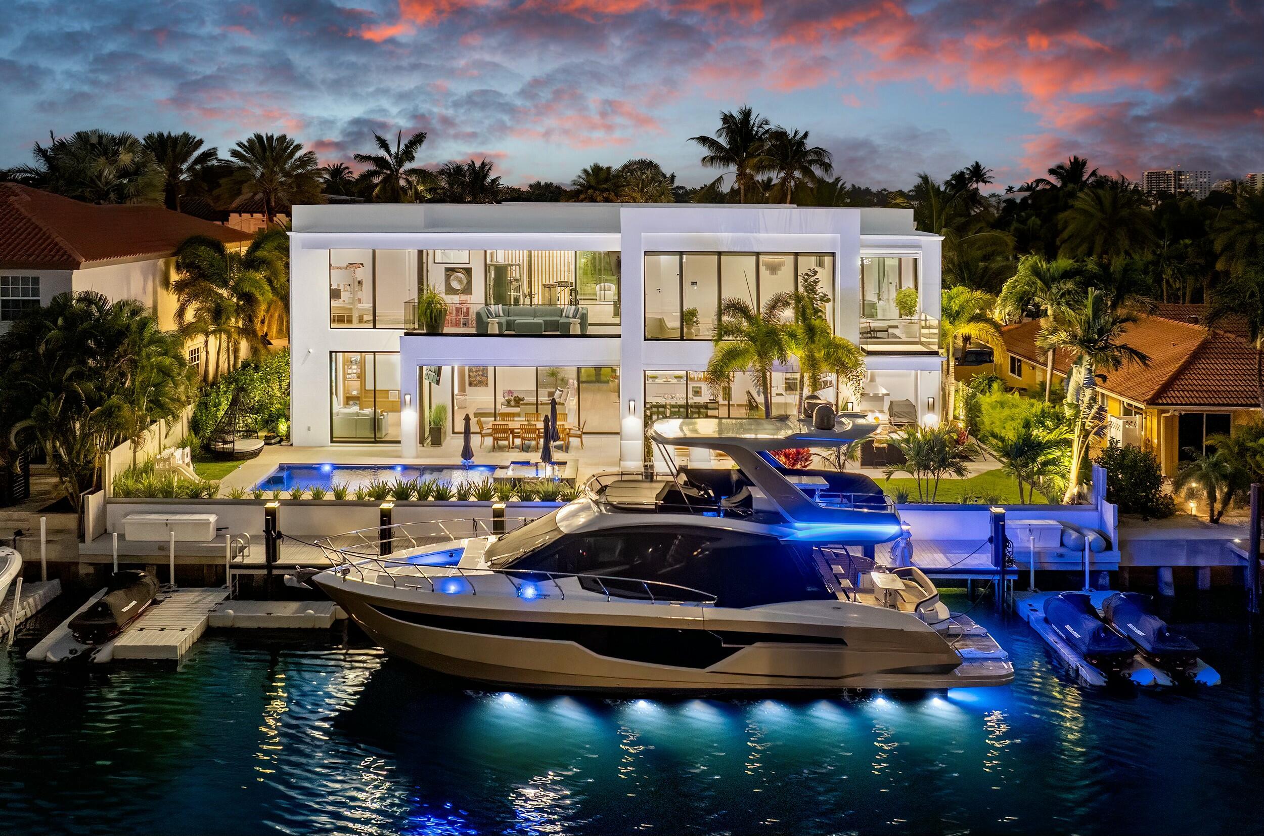 Villa Mariner, nestled along the tranquil shores of a wide, deep-water, canal just off the Intracoastal Waterway, 772 Glouchester Street in Boca Raton is a true masterpiece of contemporary design. Completed in April 2024, this two-story residence blends world-class amenities with sophisticated architecture, offering a luxurious waterfront sanctuary where elegance meets innovation. 

Spanning 6,870 square feet, this estate features 5 bedrooms and 6 bathrooms, seamlessly integrating modern sophistication with cutting-edge smart home technology. A grand 23-foot atrium entry introduces a light-filled living space, where floor-to-ceiling windows frame stunning water views. A 500-bottle, climate-controlled wine cellar, integrated into the atrium, is a striking feature, elevating the home's appeal. Custom European solid-wood cabinetry, a Control 4 automation system, and a chef's kitchen with Wolf, SubZero, and Cove appliances further enhance the estate. A wet bar with dual beverage refrigerators and a wine fridge adds to the entertainment value. 

The main floor offers a great room with two sets of sliding doors to the oversized covered patio, creating seamless indoor-outdoor living. A clubroom with views of the pool and Intracoastal canal is ideal for relaxation, while a first-floor VIP suite ensures privacy and comfort for guests. 

Upstairs, the private primary suite boasts panoramic water views and a spa-inspired bath featuring dual rain showers, a soaking tub, and designer finishes. Custom closets blend style and functionality, with built-in outlets and LED lighting. A private gym equipped with a Tonal system offers a dedicated space for personal wellness. Both the primary suite and gym lead to a spacious covered balcony, where expansive waterfront views create an inviting outdoor retreat.  

Outdoors, the lushly landscaped retreat features a 15' x 35' PebbleTech saltwater pool and oversized spa, complemented by elegant waterfalls and sophisticated lighting. The outdoor kitchen, with a Lynx Sedona grill, pizza oven, and refrigeration, is perfect for alfresco dining. With 90 feet of water frontage, the estate is a haven for yachting enthusiasts, offering a fully equipped dock with a new seawall cap, power connections, and ample space for a large yacht and watercraft. 

A fully air-conditioned, lift ready, 3-car garage with car-charging circuit and a golf simulator adds to the luxurious lifestyle. Practical features like a whole-house generator, dual instant hot water heaters, and a UV filtration system provide peace of mind, while advanced security with 12 exterior cameras ensures unmatched protection. 

From the gated entry to the bespoke garage doors, 772 Glouchester Street combines luxury, functionality, and waterfront living. Whether relaxing by the pool, docking your yacht, or enjoying a private balcony, this estate offers unparalleled elegance. 

Located in the Boca Keys community in northeast Boca Raton, 772 Glouchester is perfectly positioned between downtown Boca Raton, downtown Delray Beach, the world-renowned Boca Raton Club, and all the finest offerings of South Florida.