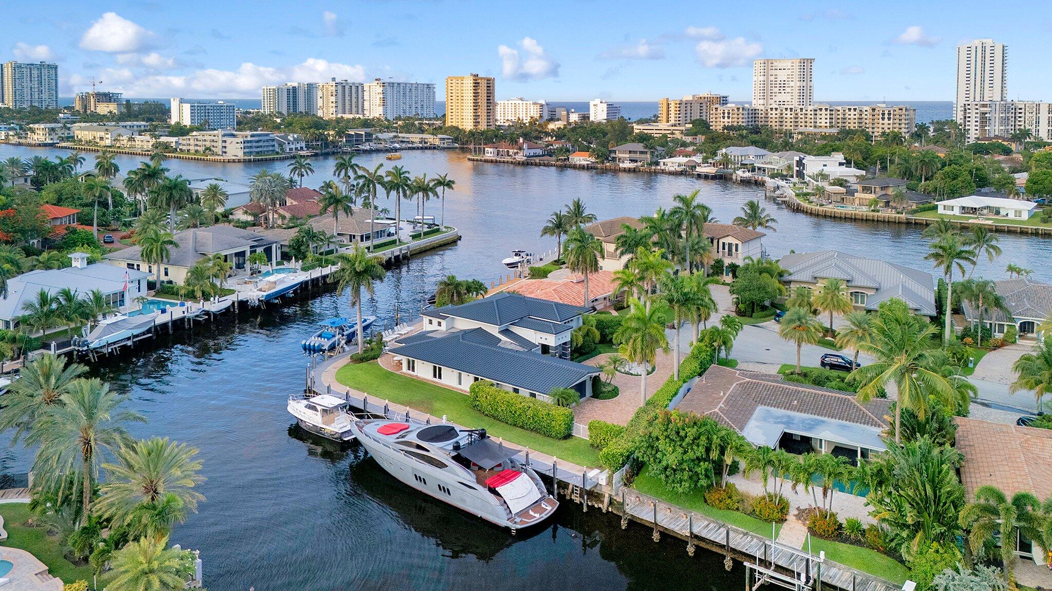 Yachtsman Dream!! 225' of dock space, point lot, deep water, direct ICW, turning basin, 27,000 LB lift, electric andwater on the dock, 10 min to Hillsborough inlet. This home will house any size boat!! 5 bed/4.5 bath with an office,in-law and or crew quarters with its own private entry. The layout of this home is perfect for entertaining, thekitchen has a 6 burner Wolf range and a huge island and Sub Zero appliances. The grand foyer, stacked stonefireplace, wet bar, two family rooms that open to the Lani, the home was designed so each room has a view of theintracoastal. Upstairs is the primary that opens up to a 20x30 private balcony that overlooks the pool and the canal.If you have been looking for a private, waterfront estate to house your yacht and entertain in this is it!!