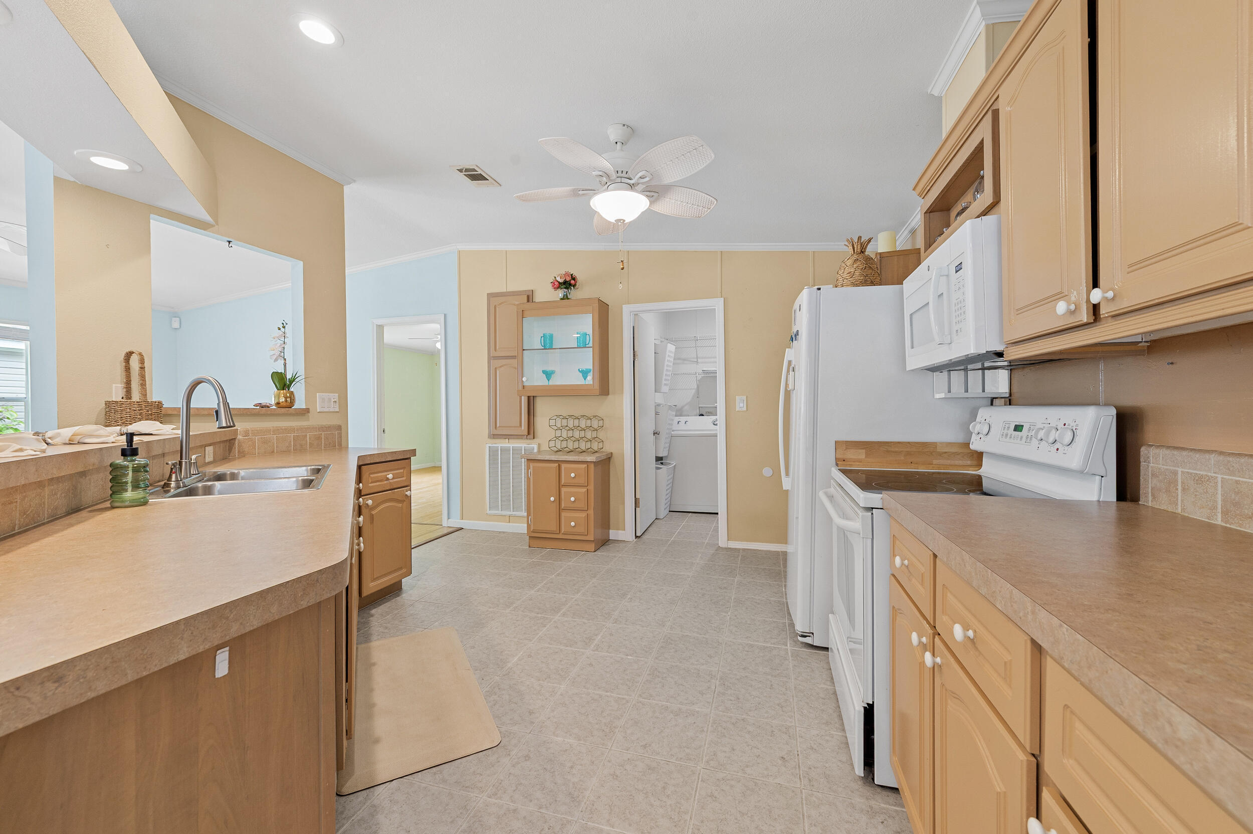 Welcome to this charming 3-bedroom, 2-bathroom waterfront home located in The Meadows of Palm Beach Gardens. This single-story manufactured home offers 1,450 square feet of thoughtfully designed living space. The convenient 2-car garage provides excellent storage and parking solutions for multiple vehicles. The All-age Meadows community boasts an open layout and a distinctive climate-controlled garage with its own driveway access. Recent upgrades feature a new roof from 2021, refreshed garage air conditioning in 2023, a home AC unit replaced in 2019, and modern appliances throughout. The main bathroom showcases dual sinks, a walk-in shower with two seats, and a spacious walk-in closet. The amenities include pool, hot tub, exercise room, playground area, Picnic area, basketball, RV/boat storage, Laundry facilities, community activities, clubhouse and 2.5 Miles to Coastal US.