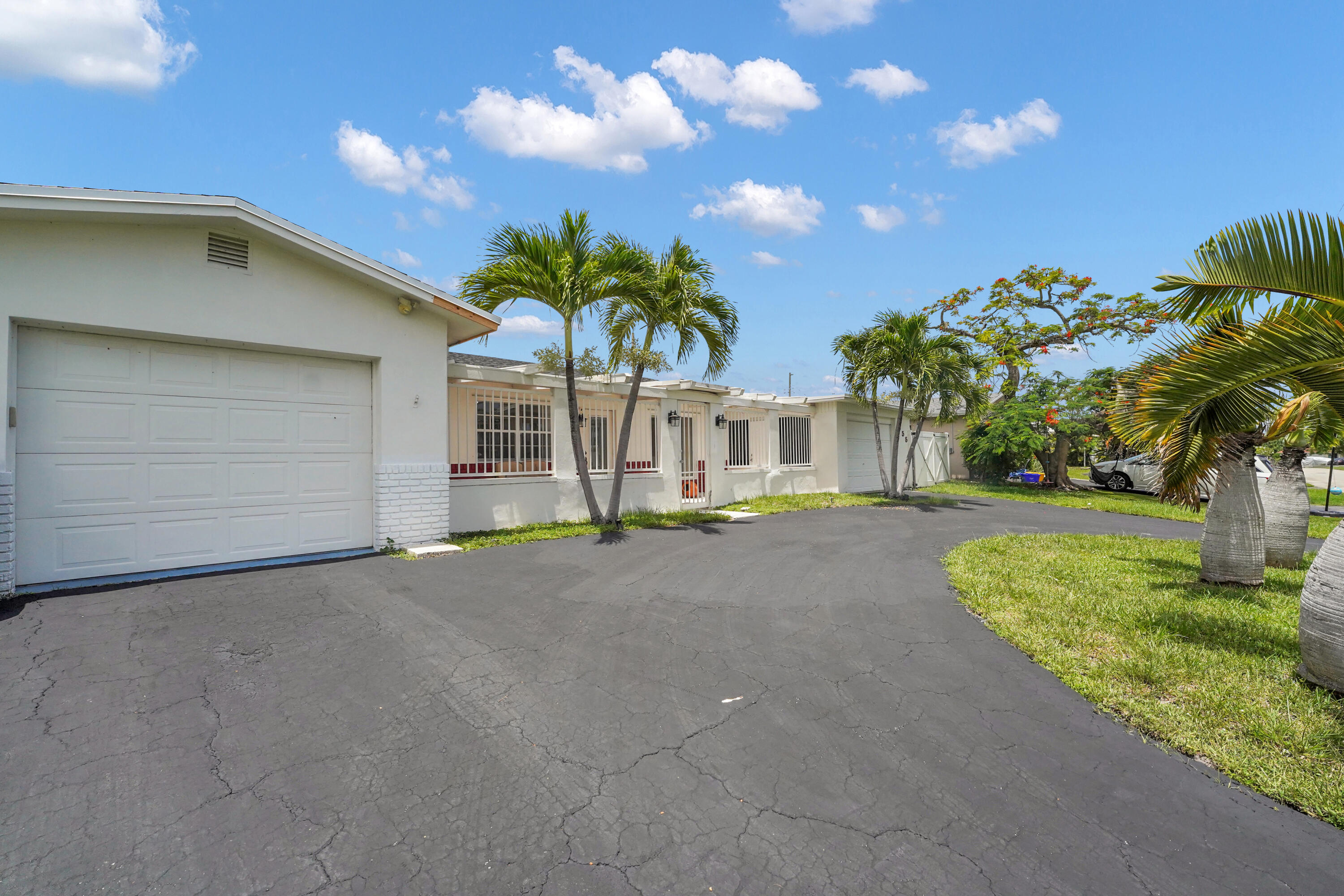 NO HOA! Move in Ready, Freshly painted 3-bedroom, 3-bath home with a convertible 4th bedroom in one of East Boca's most desirable neighborhoods. This home features 24" Porcelain tile flooring throughout, stainless steel appliances, and a charming exposed brick accent wall. Two separate garages. One garage finished with tile flooring, in addition to a kitchenette, and a full bath—ideal for guests, a home office, gym, or in-law suite. Enjoy your very own private backyard oasis with plenty of green space and a huge saltwater in-ground pool, perfect for relaxing or entertaining. Major updates include a NEW Roof, NEW A/C, NEW Hot Water Heater, NEW Attic insulation, and a Newly resurfaced circular driveway. Minutes from Boca's Beautiful Beaches, Shopping, Dining, & Entertainment! Welcome Home!