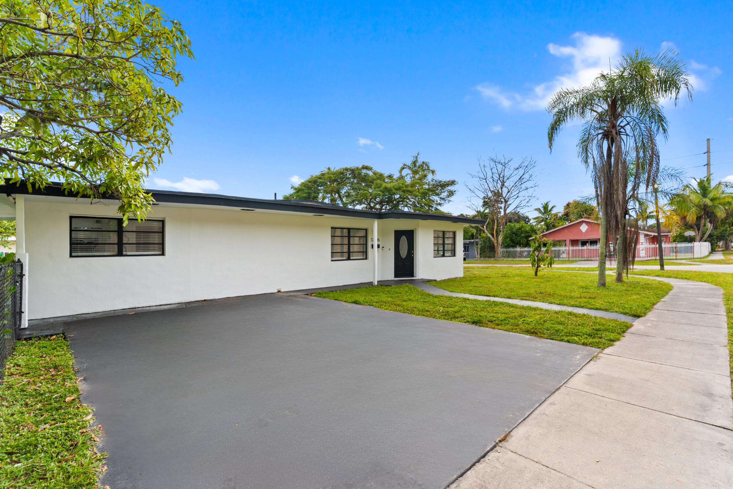 Lowest-priced renovated single-family home on the market and the largest corner lot available under 600k! An exceptional opportunity for a first-time buyer or an income-producing investment.  This beautifully updated home features new tile flooring throughout and a split-bedroom floor plan. The spacious primary suite offers a walk-in closet and a brand-new, modern bathroom. Two additional bedrooms are generously sized, while a fourth bonus bedroom is perfect for bunk beds, a kids' room, home office, or creative flex space. Tankless water heater and a/c are 2022.  The open-concept kitchen showcases quartz countertops, stainless steel appliances and a sizable dining area. No HOA! Set on an oversized corner lot, the property offers ample room for future expansion including the potential for a mother-in-law suite, home addition, pool, shed, or outdoor entertaining areas. The fully fenced yard is enhanced with newly planted privacy hedges that will mature to approximately 6 feet tall, creating a private and serene outdoor oasis. So much space, so many possibilities.  Perfectly situated for South Florida living, the beach, Wynwood, Midtown, Bal Harbour, Brickell, Downtown Miami, Hardrock Stadium, Kaseya Center, Miami Airport are all within 11 miles or much less.