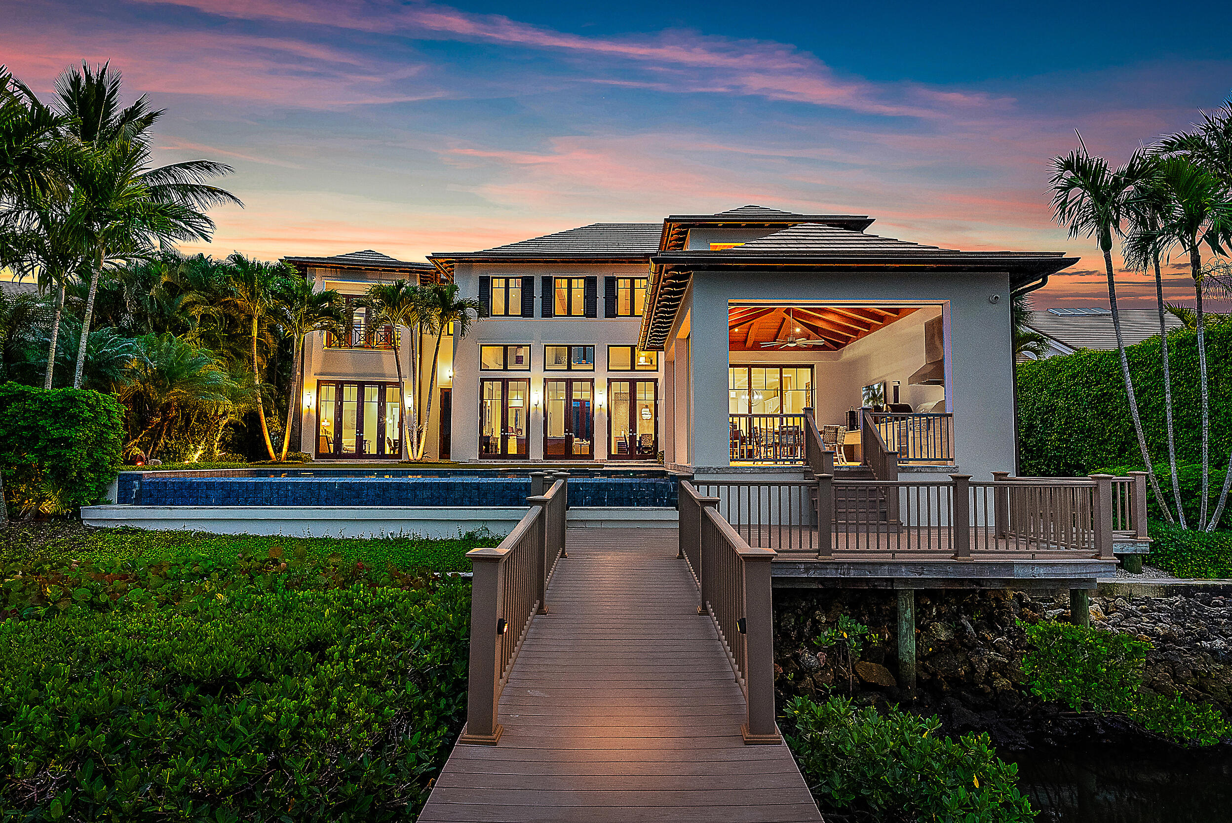 This custom waterfront home built by the award-winning Turtle Beach Construction features jaw-dropping wide water views from the moment you step through the door. Every inch of this immaculate home features the finest attention to details and luxurious finishes. The Primary Suite is the ultimate indulgence with 2 full baths, 2 expansive walk-in closets and a welcoming sitting area with waterfront views. With an additional bedroom on the 1st floor and 2 more en-suite on the 2nd floor, this home has everything you could desire. The lanai boasts a summer kitchen, electric screens and hurricane panels, and a champagne edge pool with a spa. Every day will feel like paradise. Welcome home!