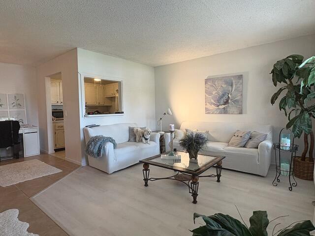 Charming 1 1/2 FIRST FLOOR condo at Century Village! Located in a quiet 55 plus gated community! Prime location near the main entrance on Okechobee Blvd. Professionally landscaped! Walking distance to the library, Dunkin Donuts, hair salon, and banks! Just minutes from the beaches! This condo features updated bathrooms, step in tub, lots of natural light, a lush tropical BBQ seating area for your  enjoyment and relaxation!  Clubhouse has its own movie theater, Las Vegas shows, a variety of classes, over 20 pools, sauna, healthclub, sailing, trash removal, tennis and courtesy bus! Condo is owner occupied. Small pets welcome! Comes furnished but owner will consider partially or unfurnished as well!! Don't miss this GROUND FLOOR opportunity!   Newer AC units.