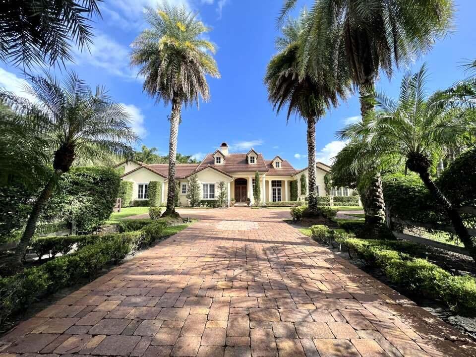 Better pictures coming!! This stunning 2..42acre farm is absolute perfection for any dressage rider. Traditional in design it is a complete luxury package with every detail incredibly  well maintained. Including a  huge gourmet kitchen stocked with newer appliances, Sub Zero refrigerator,  5 stately bedrooms each with their own bath, media room, 2 tremendous laundry rooms, dog shower, tons of storage, large formal dining, impact glass and much more.. The outside saltwater pool/spa and summer kitchen area is similar to a high end hotel.  A beautiful 7 stall barn includes a new Dressage ring with mirrors and a full size grooms apartment. Gas propane 1000 gallon tank  Tons of room to enlarge the ring for grand prix riders