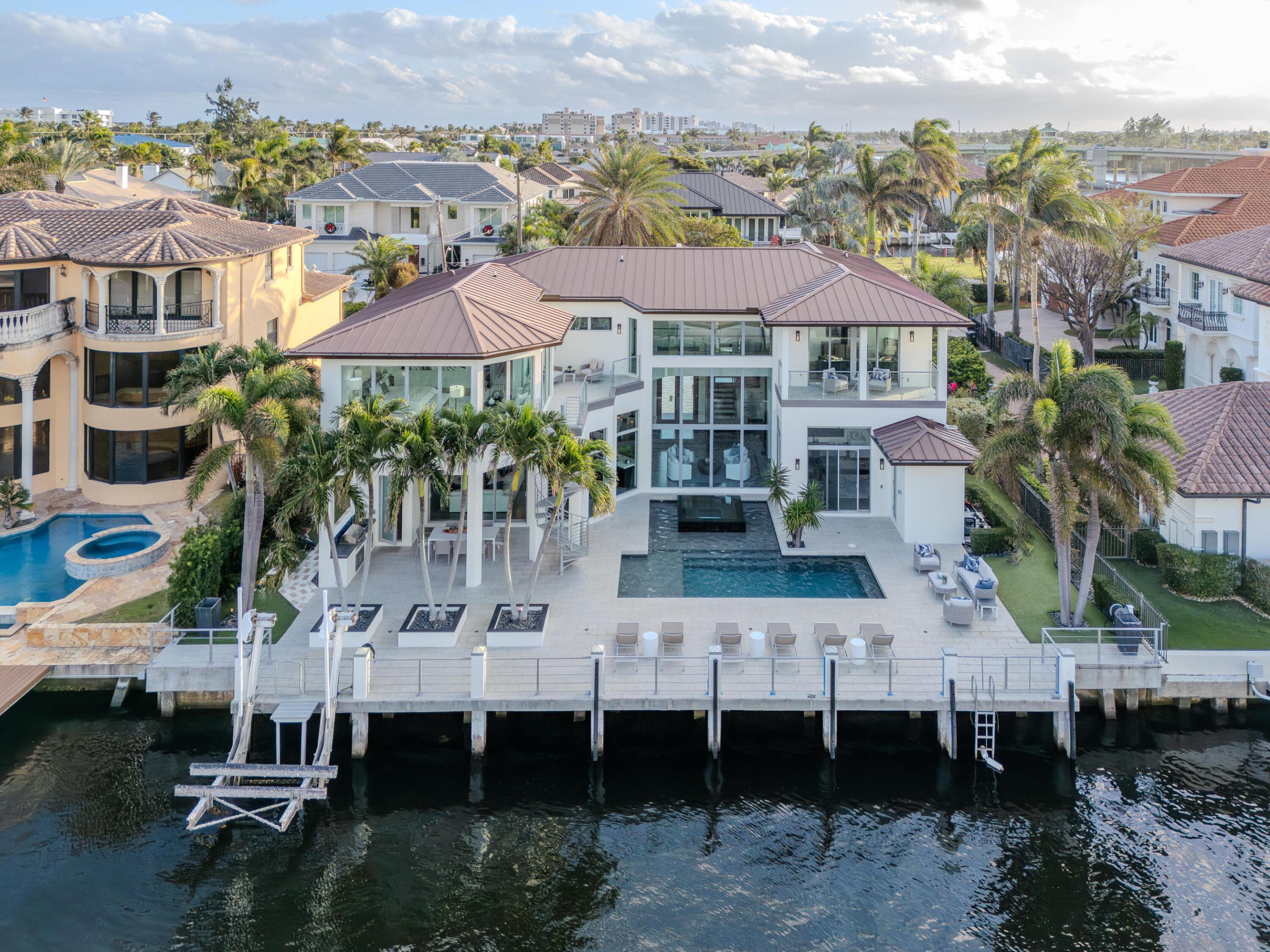 Debuting January 5th 2024, is 1005 Rhodes Villa Ave.  Designed with a nod to modernism yet embraced with warmth from an impressive wall of glass, you are immersed with both natural sunlight and gorgeous views of the intracoastal.  Superbly positioned on the barrier island, you are within mere steps to Atlantic Dunes Beach whilst also being within close proximity to famed Atlantic Ave.  

There is absolutely nothing like 1005 Rhodes Villa on the market today; with 90' of water frontage on Delray Beach's barrier island, an exquisite lot positioned only one home away from the end of the channel and endless design elements that make this estate exquisite. 

Additional photos and information to be issued on January 4th.  RSVP for the Public intracoastal waterway with no fixed bridges on your way to the ocean.  

Designed with the intent to entertain, the open concept floor plan has an embracing feeling intertwining the kitchen with the living room and dining area.  A mud room or butlers pantry can be found off the kitchen as you make your way to the 1 car garage on the Eastern portion of the home.  Ornate tray ceilings add a phenomenal element to the living room with recessed lighting throughout.  With one bedroom and a full bathroom downstairs, the remaining beds and Primary bedroom are located upstairs.  With a loft and balcony over looking the intracoastal, this room can be ideal for a second living room or a second office.  

The primary suite is accessed through a double door entry way at the end of the hallway where you will find an office space or gym area with its own private balcony access.  Two walk-in closets within the primary provide for ample storage for both him and her.  The primary bath has a separate soaking tub adjacent to a frameless rain shower and dual vanities.  The most impressive part of the estate is certainly the primary bedroom vantage.  A direct view of the intracoastal with floor to ceiling windows all around, electronic window treatments permit for limiting the abundance of natural light if you decide to do so.  

1005 Rhodes Villa Avenue is a home unlike any other on the barrier island today.  Come see it for yourself!