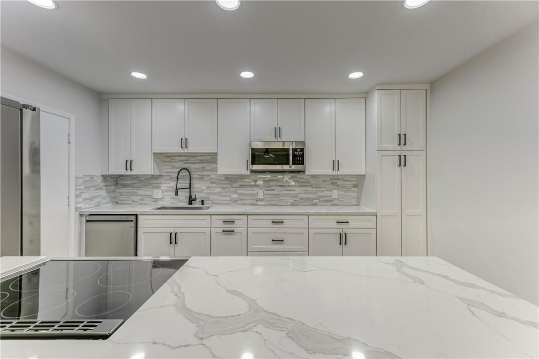 BRAND new high end kitchen with quartz counters. First floor corner unit in highly desired Imperial Point neighborhood.  A LOT of kithcen counter space, tons of cabinetry, drawers and large pantry. BRAND new upgraded stainless steel appliances including dishwasher and microwave. New lighting throughout, 3 brand new ceiling fans with remotes, brand new blinds, freshly painted, BRAND new high end vinyl flooring throughout (looks like laminate wood). Both the full bathroom and half bathroom (in master) have some updates. Spacious living room, large master suite, good amount of natural light. NEW water heater, A/C is 2017. Large storage locker in the building for extra storage. Parking spot right in front of the unit. Heated pool, updated clubroom w/pool table, kitchen, new pool furniture.