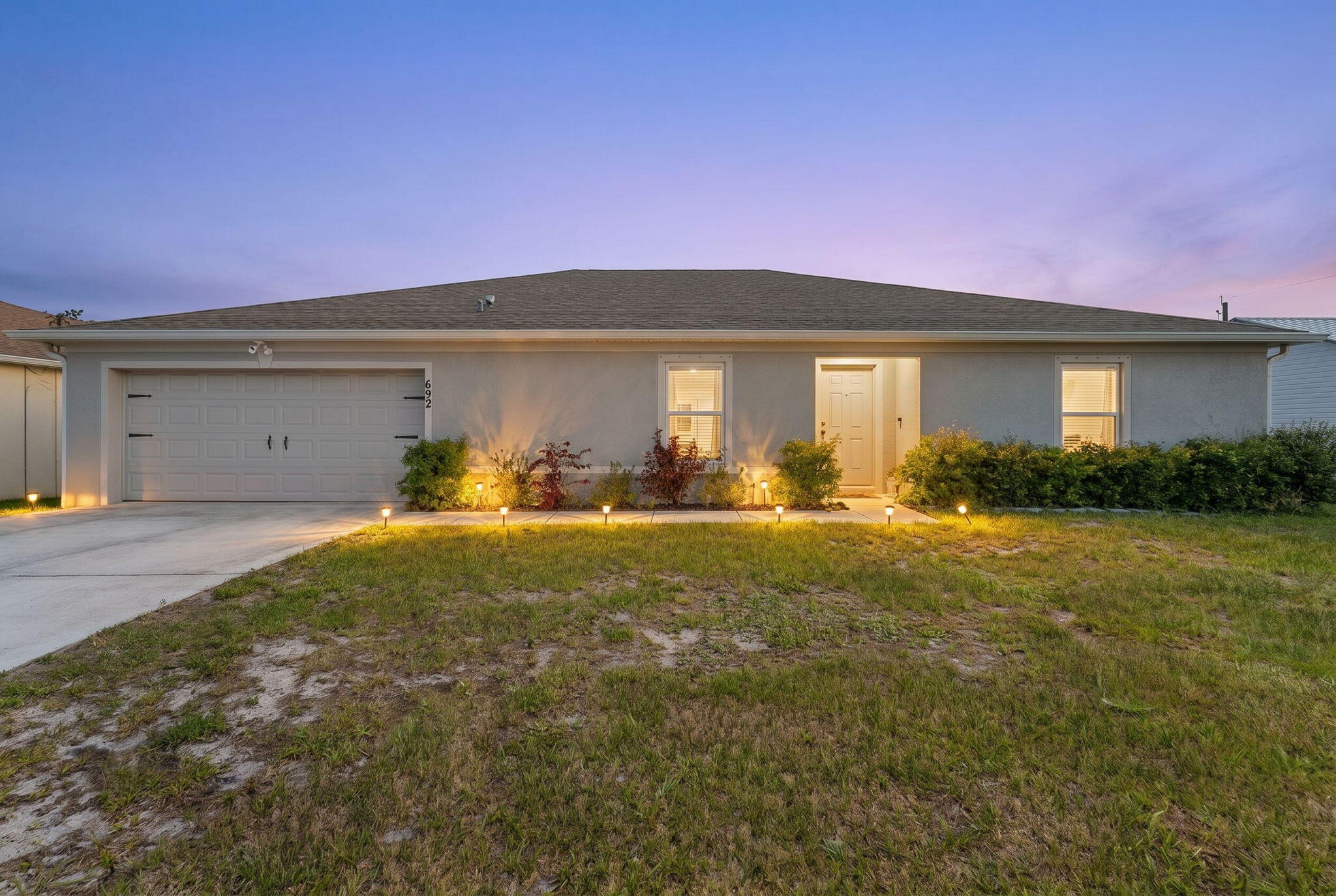 Built in 2022, this beautifully designed 4-bedroom + den home offers the perfect blend of modern style, functionality, and convenience. From the moment you step inside, you'll appreciate the bright open-concept layout that creates a seamless flow between the living, dining, and kitchen spaces—ideal for both everyday living and entertaining guests. The thoughtfully designed floor plan provides flexibility, with a spacious den that can easily serve as a home office, media room, playroom, or even a guest retreat.  The home features two well-appointed bathrooms and stylish new vinyl flooring throughout the main living areas, adding both durability and a fresh contemporary feel.  The spacious kitchen opens directly to the main living space, making it easy to stay connected whether you're preparing meals, hosting gatherings, or simply enjoying a quiet evening at home.  The private fenced backyard offers plenty of room for pets, play, outdoor entertaining, or even creating your dream pool oasis. Whether you're enjoying morning coffee outside or weekend barbecues with friends and family, this outdoor space offers privacy and endless potential.  Location is a major highlight, with quick access to both I-95 and Florida's Turnpike, making commuting a breeze. Just minutes from Tradition, you'll enjoy one of the area's most desirable lifestyle hubs, featuring popular restaurants, shopping, entertainment, community events, parks, and more. This newer construction home delivers the peace of mind of modern building standards combined with the convenience of being close to everything you need.  A perfect opportunity to enjoy newer construction living in a prime location without the wait to build.