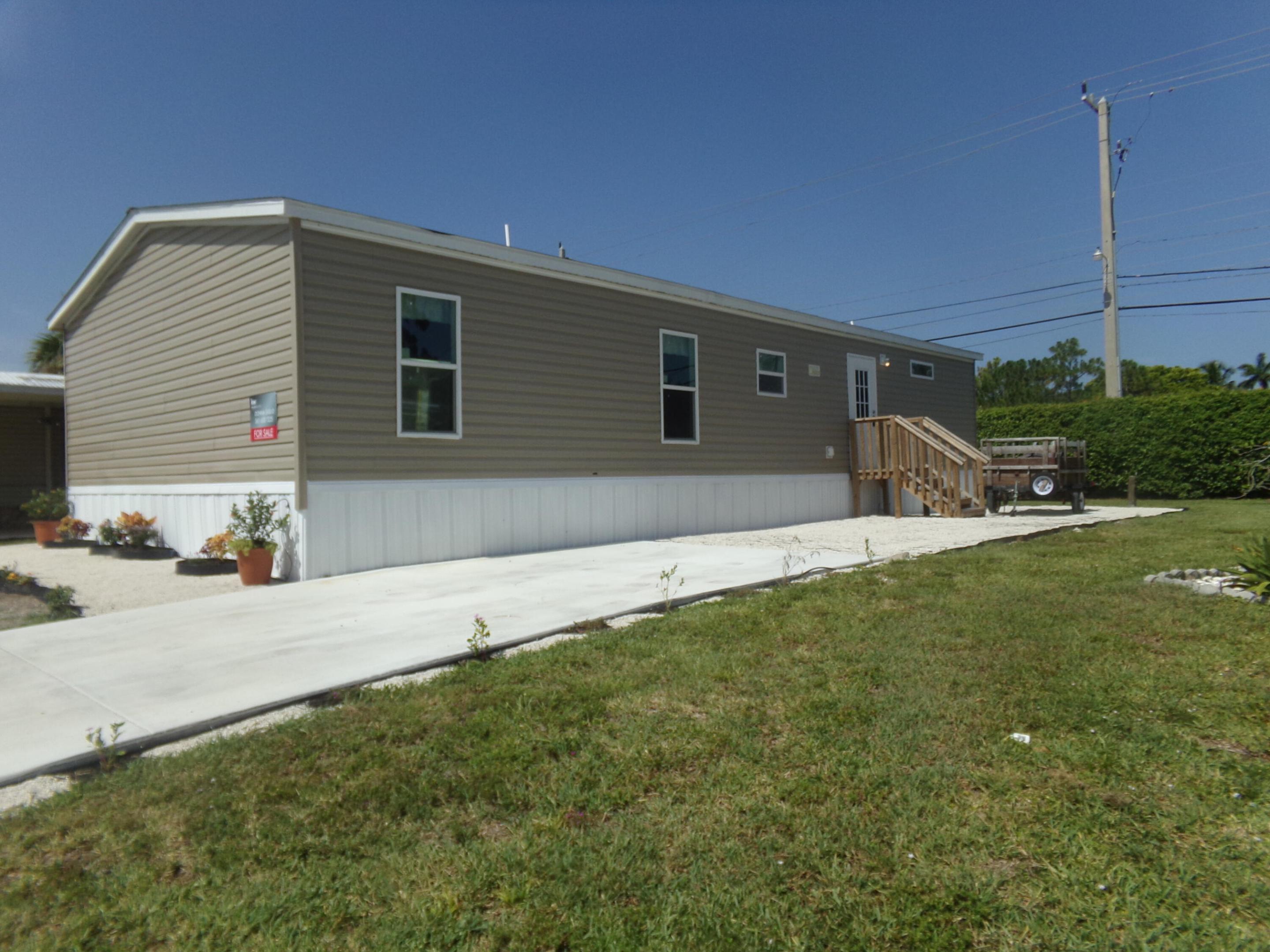 Welcome to this charming 3-bedroom, 2-bathroom manufactured home located in Jamaica Bay Mobile Home Co-op in Boynton Beach, Florida. Offering 1,352 square feet of finished living space on a single floor, this property provides comfortable and convenient one-level living. The thoughtful layout accommodates multiple bedrooms and bathrooms, making efficient use of the available square footage. Situated within an established mobile home community, this residence presents an excellent opportunity for those seeking affordable, practical housing in the Boynton Beach area. In addition to the beauty of this home, the bathrooms have been remodeled with high end features. the sellers are offering a 5 year warranty on bathrooms in addition to the home's 10 year warranty!  Buyer also has choice of replacing bedroom carpet with flooring. This house will also include an attached carport and a shed on a concrete foundation. This is a rare opportunity to own a brand new home in Jamaica Bay. NO LAND LEASE. HOA is only 270 per month! Gated community. Don't wait on this one