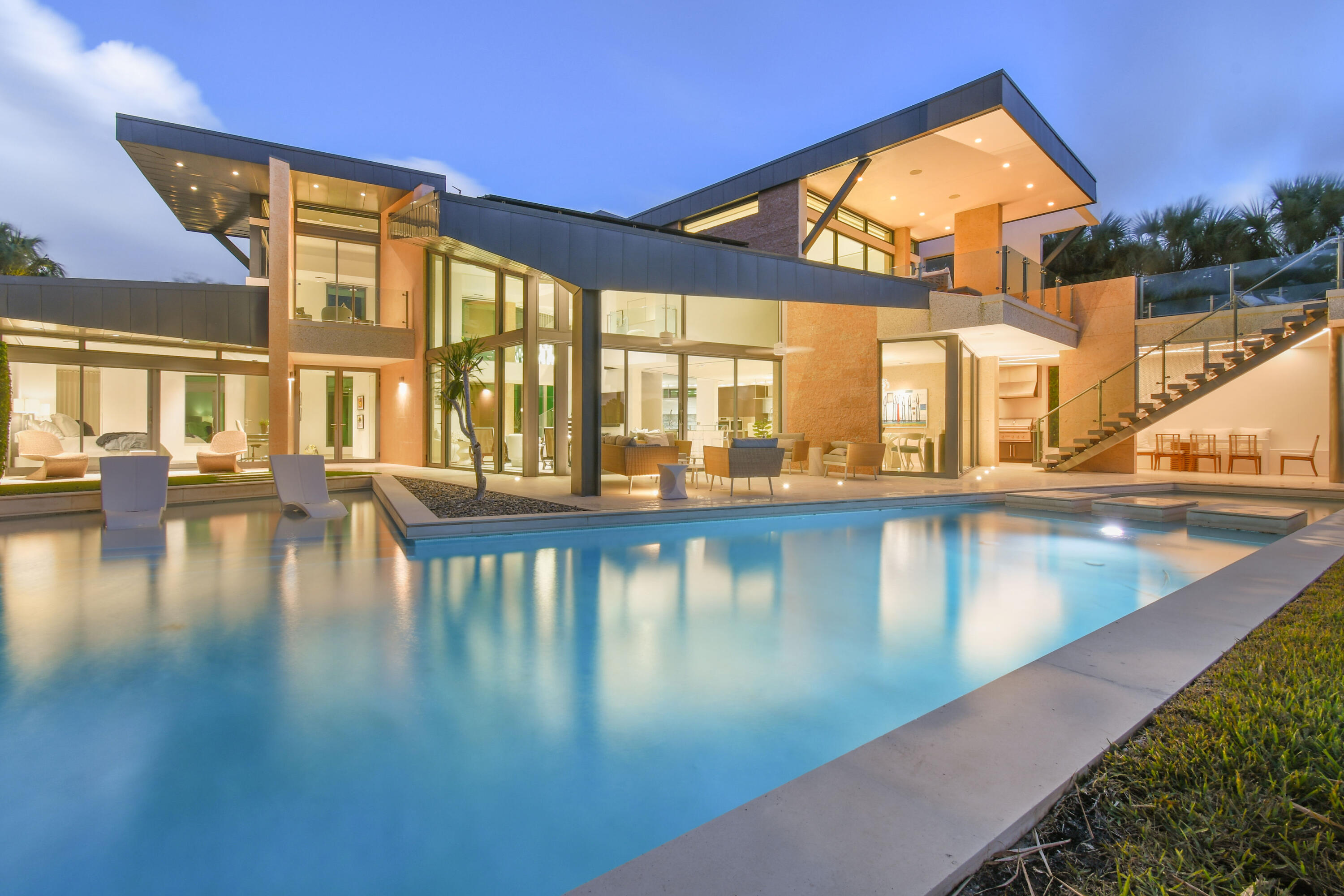 A rare contemporary gem situated with stunning views of the pristine Intracoastal Waterway and the iconic Jupiter Lighthouse. Experience the epitome of Jupiter's crystal-clear waters, just minutes away from waterfront dining, the inlet, and a plethora of aquatic activities. No expenses were spared in creating this 6-bedroom, 8 ½-bathroom dream home in the prestigious Jupiter Inlet Colony. This residence embodies the pinnacle of quality, craftsmanship, technology, and design. Every detail, from hand-selected modern features to clean and elegant lines, showcases the highest quality finishes and top-of-the-line amenities. The kitchen is a Boffi masterpiece, featuring Gaggenau, Sub-Zero, Meile, and Nanna appliances. A 600-bottle wine cellar, a state-of-the-art gym with a steam room and shower, along with a total immersion soaking tub, make this home a true luxury retreat. Home comes fully equipped with solar panels reducing the electric bill to under $220/month. Additionally, there's a private rooftop sun deck to enjoy. Full home Control-4 automation system featuring audio, visual, and shade control. This architectural marvel was designed to embrace the outdoor lifestyle, boasting an outdoor covered loggia with a summer kitchen, a resort-style pool with a grand water wall, and a dock with a lift, all overlooking the pristine waterway and the lighthouse. 
Video tour https://youtu.be/MEf7Xdr3i_4?si=CKFn7cJwABFEwL21
