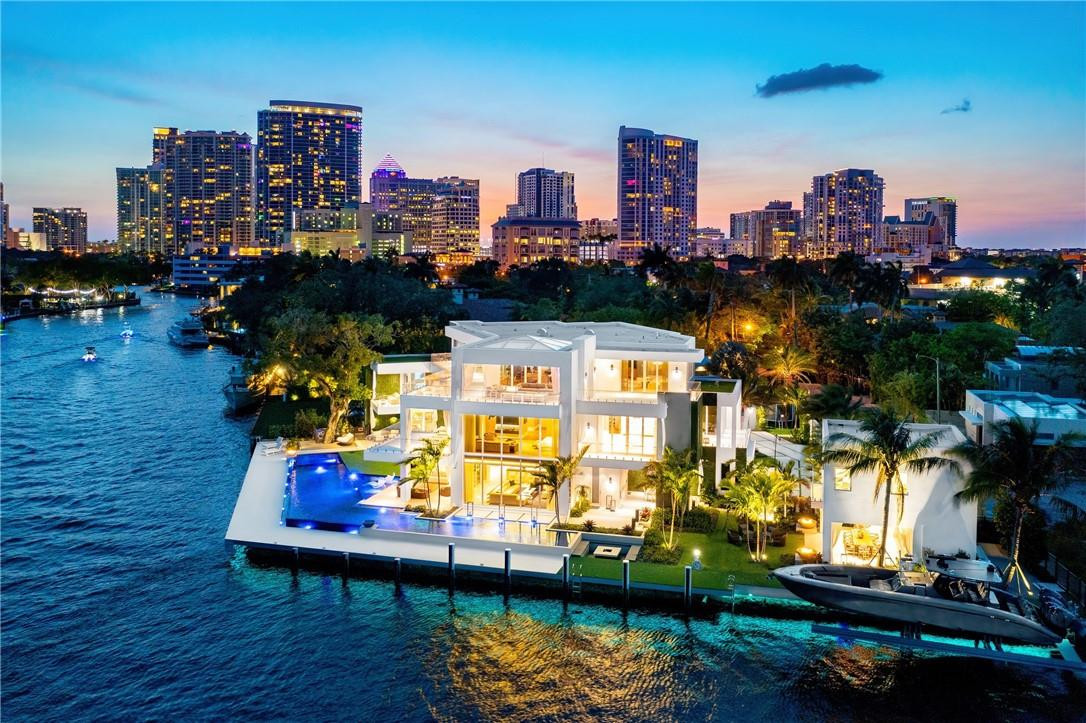 Breathtaking one-of-a-kind estate! This modern 3-story point lot offers 250' of deep WF. Bright, open floor plan boasts breathtaking River views. Fastidious craftsmanship & attention to detail w/ultra high-end finishes throughout. Luxurious features include game room, theater, temp controlled wine cellar, generator, natural & propane gas, boat lift, oversized kitchen, guest house & 3rd level club room. Huge primary suite w/water views, his & hers baths, closets & massage room.  Also find a gym & spa that can be converted into a secondary suite.   Resort style backyard w/lap pool & numerous covered lounging areas. Located in gated Sagamore Cove in Las Olas Isles. With quick & easy access to the ICW & inlet, this location is a yacht owner's paradise! Walking distance to Las Olas restaurants.