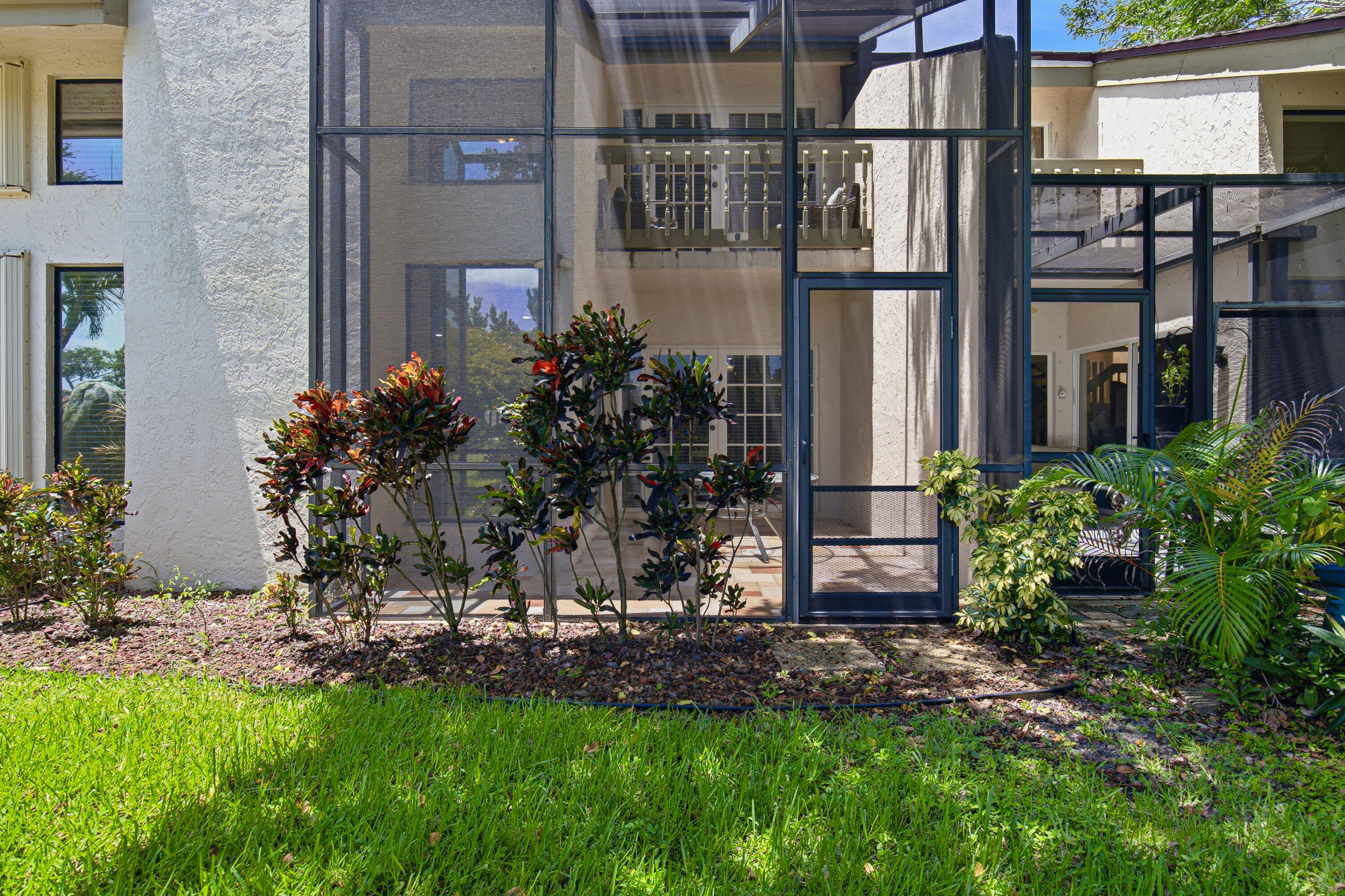 Beautifully maintained 3-bedroom, 2.5-bath townhome with a one-car garage, ideally situated on a private waterfront lot with mature shade trees and tranquil views. Light and bright throughout, this home features soaring ceilings and a custom architectural feel that creates an open, airy ambiance. One of the few homes in the community with a grandfathered two-story screened enclosure—a rare feature no longer permitted—offering exceptional indoor-outdoor living space. The newer roof provides added peace of mind. Just steps from the community pool and within walking distance to restaurants, shopping, and places of worship, this home is perfectly located in the heart of desirable East Boca Raton.  Whether you're looking for a full-time residence or a seasonal retreat, this attractively priced waterfront townhome is a rare opportunity.