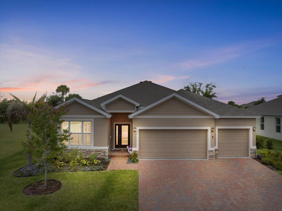 Luxury meets lifestyle in this exceptional 2024-built residence located within the gated community of Grande Hammock in the heart of Vero Beach. Designed with elevated finishes, thoughtful upgrades, and expansive indoor-outdoor living, this full 3-bedroom, 3-bath home offers the perfect blend of modern sophistication and Florida comfort.  Step inside to a bright and airy split open floor plan featuring upgraded tile flooring throughout, designer shiplap accent walls, and a stunning chef-inspired kitchen centered around double quartz islands, abundant cabinetry, slide-out drawers, premium hardware, and expansive prep and entertaining space. The luxurious primary suite showcases stylish barn doors, spa-inspired touches, and added water filtration in the primary bath for enhanced comfort. The oversized 27x27 screened lanai creates a true outdoor retreat complete with a hot tub and ample room for lounging, dining, and entertaining year-round. Additional upgrades include a spacious 3-car garage, interior laundry room with cabinetry, ADT security system, custom blinds, upgraded fans, manicured hedge landscaping, and numerous high-end finish enhancements throughout.  Perfectly positioned just minutes from shopping, dining, and everyday conveniences, this home is approximately 5 miles from Downtown Vero Beach and Vero Beach Regional Airport, while being less than 8 miles from the pristine beaches and Atlantic coastline that make Vero Beach one of Florida's most desirable coastal communities.