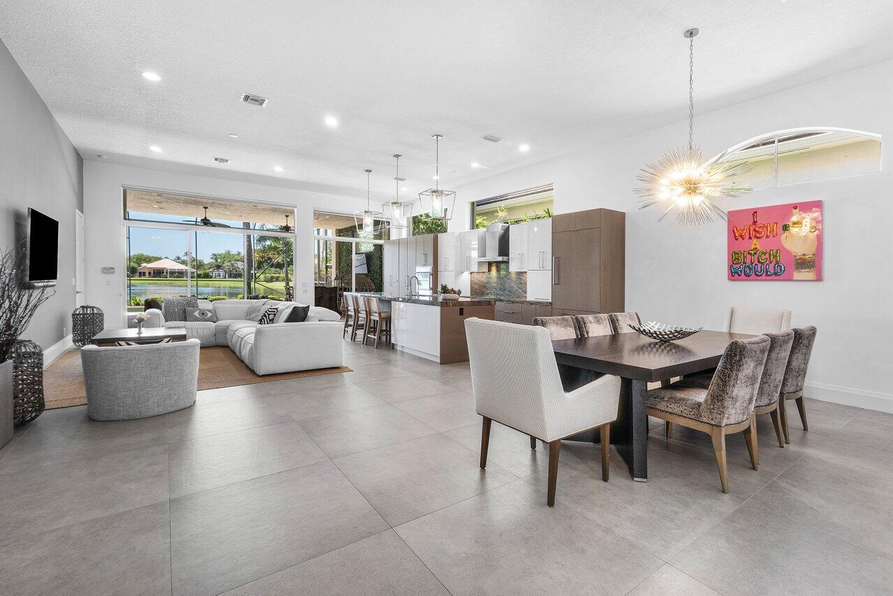 Immediate Full Golf Membership allowing you to bypass the Club's waitlist! Welcome to 105 Island Cove Way in award-winning BallenIsles Country Club. This exceptional move-in-ready home is beautifully renovated with a sophisticated contemporary design featuring 3 bedrooms, a spacious private office/den, 4 full bathrooms (including a cabana bath), a 2-car garage, and 2,645 square feet of living. An open-concept floor plan is enhanced by vaulted ceilings, expansive living spaces, and large-format Italian porcelain tile throughout. Natural light fills the home while drawing your attention to one of its most captivating features—a breathtaking panoramic water view visible from the moment you enter, with multiple tranquil fountains creating an unforgettable backdrop! The stunning Gourmet Kitchen is a true centerpiece, appointed with premium Thermador appliances, an induction cooktop, separate wall oven, custom two-tone cabinetry with paneled refrigerator and dishwasher, a pull-out pantry with adjustable shelving, appliance garage, hidden coffee station, and built-in knife block. An oversized island showcases an exquisite quartzite countertop, also featured as the kitchen backsplash, counter seating, a built-in wine refrigerator, microwave, dishwasher, and abundant storage.    Step outside to your private backyard oasis, where a screened lanai overlooks spectacular expansive water views, multiple serene fountains, a sparkling pool and spa, covered and open patio spaces, a summer kitchen, BBQ and a separate dining area—perfect for entertaining family and friends or relaxing after a day of golf, tennis, pickleball, or the club's many social activities.    The luxurious primary suite offers a true retreat with dual spa-inspired bathrooms, oversized custom walk-in closets, and separate showers. Two private en-suite guest bedrooms are thoughtfully situated on the opposite side of the home, providing exceptional comfort and privacy for family and visitors. A generously sized office/den is tucked away from the main living areas, creating the ideal space for working from home or enjoying a quiet retreat.    Additional features include a 2015 Flat Tile Roof, complete hurricane protection with accordion shutters (hurricane panels for the front door), HVAC air handler (2020), condenser (2011), water heater (2020), and an oversized two-car garage with an epoxy floor.    As a resident and member of BallenIsles Country Club (mandatory purchase separate from the home's purchase price), you'll enjoy one of the nation's premier private club communities, recognized as a 5-Star Platinum Club. Amenities include three championship golf courses, a brand-new 9-hole par-3 course (coming Fall/Winter 2026), an award-winning tennis and pickleball complex (21 tennis courts and 13 pickleball courts), beautifully renovated clubhouse and sports complex, six exceptional dining venues, a resort-style pool with Olympic lap lanes, state-of-the-art fitness center, full-service spa and salon, dog park, scenic walking paths, and an active calendar of social events.     Don't miss this a rare opportunity to own a beautifully renovated waterfront home while securing immediate Full Golf Membership and access to the incomparable BallenIsles lifestyle.