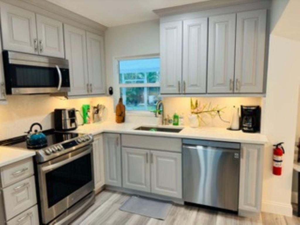 Beautifully updated Fort Lauderdale home featuring new impact windows, smart lighting, electric blinds, solar roof, HEATED POOL, fresh paint, and ceramic tile entryway. Upgrades include new driveways, sprinkler system, and over $20,000 in recent maintenance and repairs. Perfect for multi-generational living, first-time buyers, or investors seeking Airbnb potential in a prime area. Enjoy modern comfort just minutes from beaches, dining, and shopping in a family-friendly neighborhood.