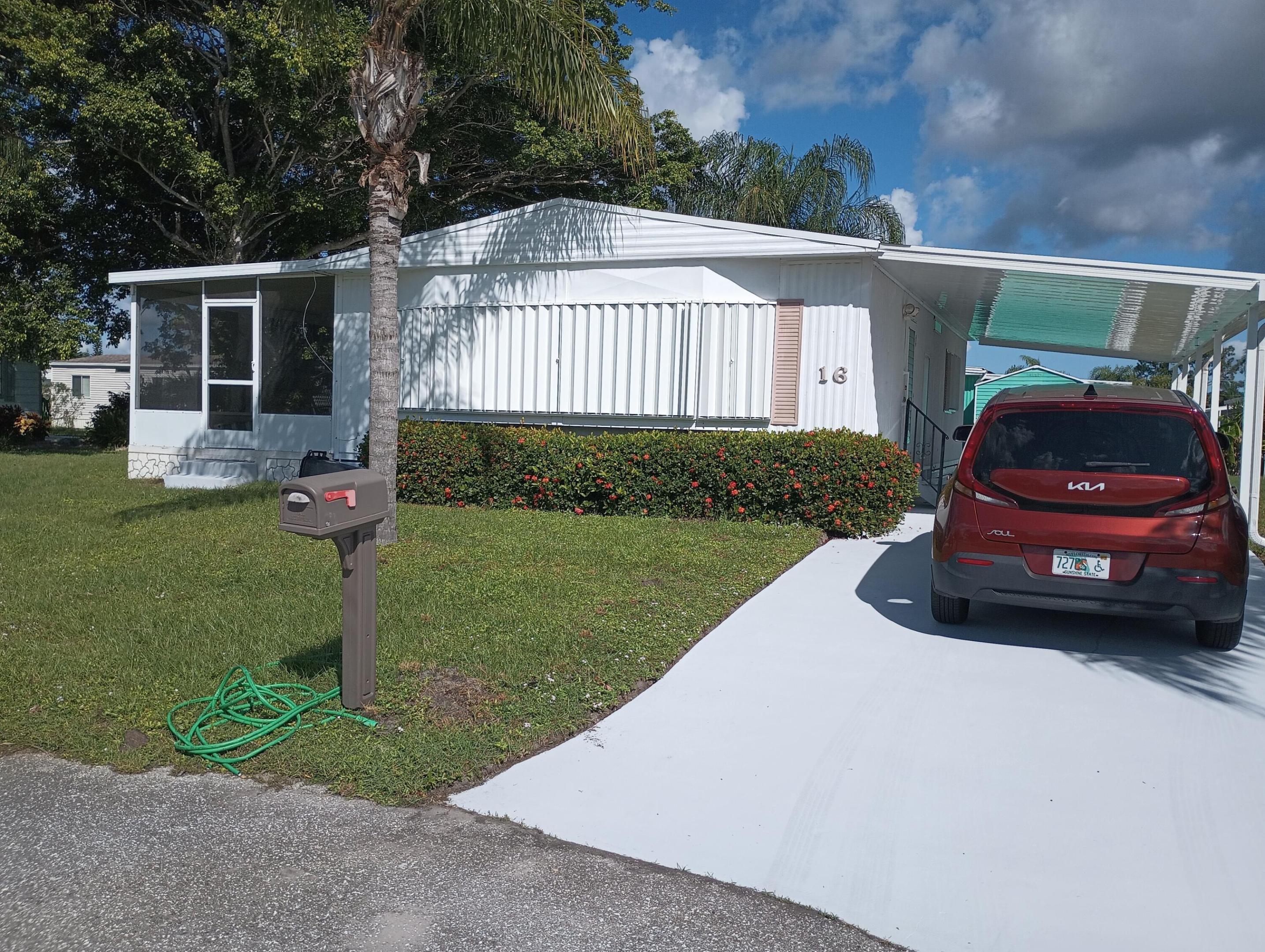 Auction minimum bid $2650 Seller reserve New Roof and new carport ,new AC Welcome to 16 Guadalupe, a beautifully maintained and move-in-ready manufactured home nestled in the heart of Spanish Lakes Golf Village, one of Port St. Lucie's most sought-after 55+ communities. This spacious 2-bedroom, 2-bath residence offers approximately 1,340 sq ft of comfortable living space with thoughtful upgrades throughout. - Open-concept living and dining area with abundant natural light - Updated kitchen with modern appliances and ample cabinet space - Primary suite with walk-in closet and en-suite bath - Guest bedroom ideal for visitors or a home office - Central A/C and ceiling fans for year-round comfort - New Buyer land lease $865.27