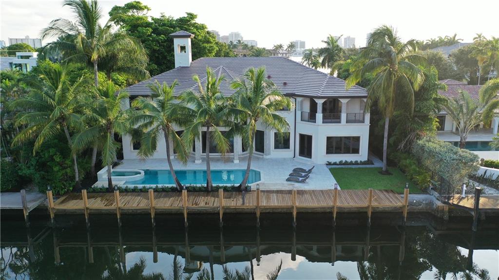 MODERN MEDITERRANEAN ELEGANCE | Imagine the luxurious life you can live in this newly completed waterfront estate. Best Value in Harbor Beach. Over 8,000 SF under air completely renovated inside and out, modern and traditional elegance blends seamlessly from room to room. Soaring ceilings and open floor plan make this perfect for entertaining. The incredible seamless modern chef's kitchen is truly a dream with whitewashed gray wood cabinets, waterfall countertops and a wall of stone operating as a focal point juxtaposed with windows showcasing contrasting greenery outside. New dock on 100' WF. Three car garage. Private Beach Club and Marina. Beautiful views of amazing mansions across the ultra wide canal. New Roof, Elevator. Entertaining room that can be converted to a home theater.