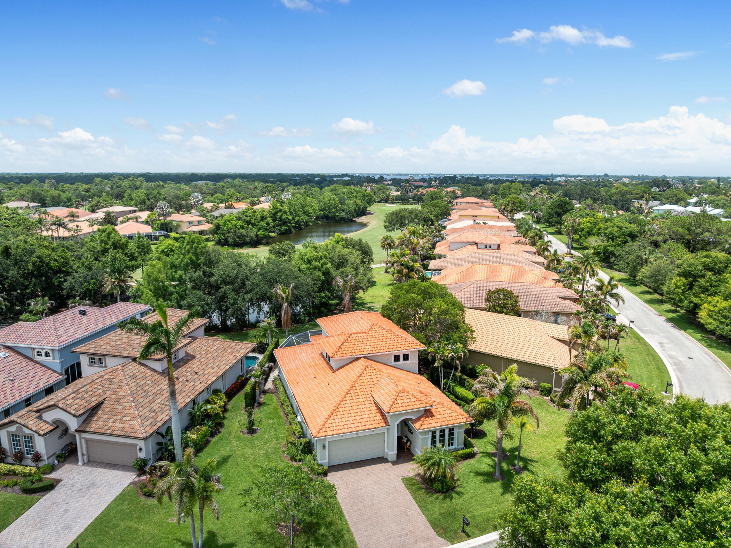 Experience refined coastal living in the gated community of Palm Cove. This impeccably maintained residence offers 3 bedrooms, 3 bathrooms, a private office, and a thoughtfully designed split floor plan with a main-level primary suite and a private second primary suite upstairs. The approximately 2,700-square-foot home features a gourmet kitchen with granite countertops, white wood cabinetry, premium stainless steel appliances, a cooktop, double ovens, and a spacious walk-in pantry. An open-concept layout flows seamlessly to an expansive screened lanai with a summer kitchen, overlooking tranquil pond and golf course views surrounded by lush tropical landscaping.  Refined details throughout include soaring volume ceilings, crown molding, plantation shutters, custom California Closet systems, an air-conditioned garage, and complete hurricane protection. Ideally located near A-rated schools, pristine beaches, exceptional dining, shopping, and major highways, this home offers both luxury and convenience. Palm Cove's resort-inspired amenities include a private 93-slip marina, non-equity golf, tennis, a riverfront clubhouse with a fitness center, library, event rooms, resort-style pool, and playground, offering an unparalleled Florida lifestyle.