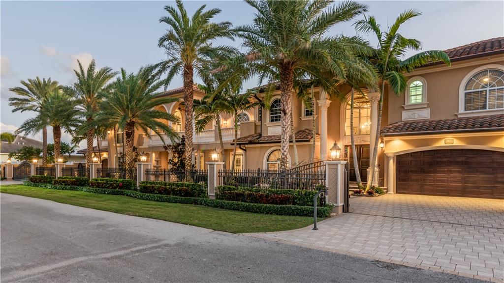 This extremely private and well appointed estate in Lighthouse Point is one of a kind. It is situated on a double lot with no visible neighbors in the front or rear of the home. An extensive rebuilding and expansion was completed in 2012 in which Schonbek chandeliers, multiple gas fireplaces, rich custom mahogany woodwork, elevator, covered loggia, resort style 70' pool with waterfall, and gas fire pit were some of the stately classic features of this estate home. The two master suites plus a VIP suite, gym, 5 bay garage, incredible club room and bar with exquisite long water views are just a few of the uniquely wonderful appointments of this one of a kind expensively custom home.    Boasting 150' on the water offers plenty of space for a yacht.