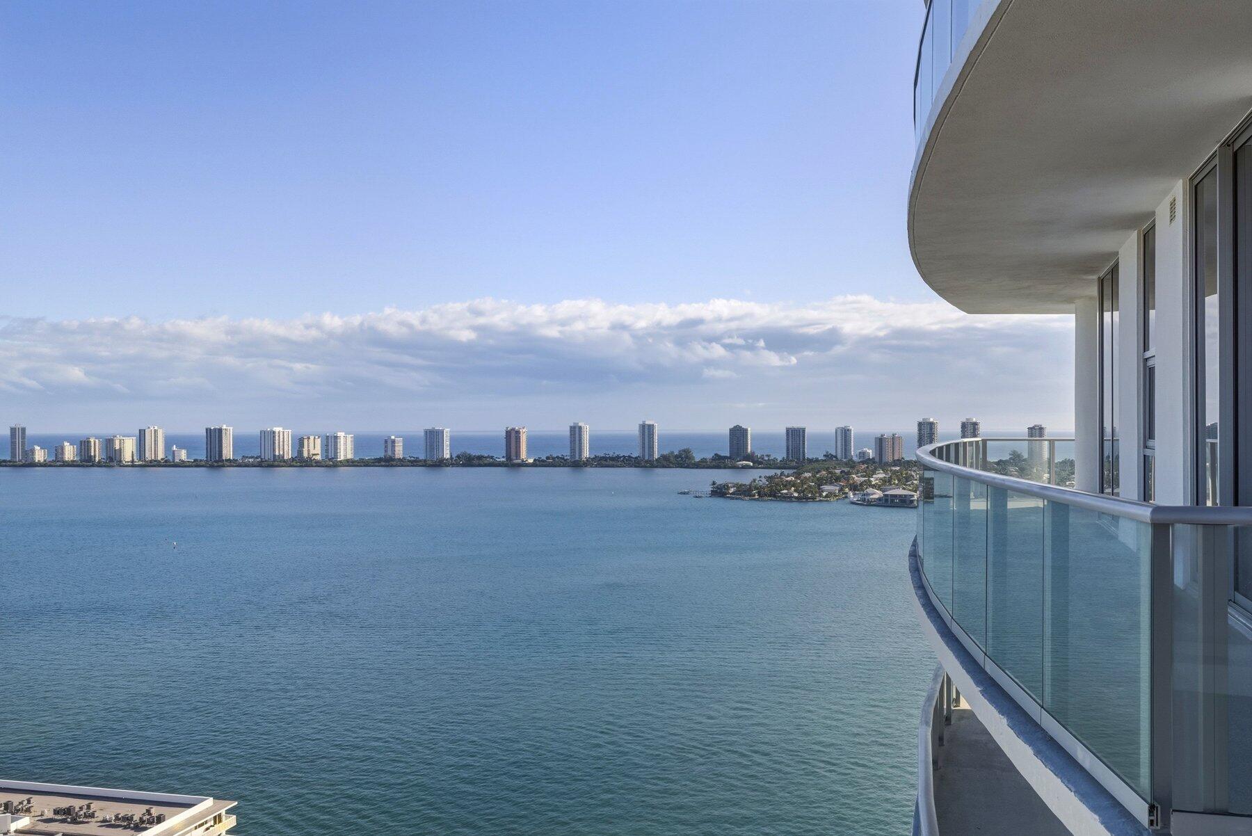 Live your BRAND-NEW penthouse life on the 23rd floor of Nautilus 220, delivering an extraordinary level of luxury with breathtaking panoramic Atlantic Ocean and Intracoastal views, THREE climate-controlled garage parking spaces, private valet service, and a lifestyle defined by truly unmatched resort-caliber amenities. Never before lived in, this exceptional residence offers the rare opportunity to own one of the building's premier sky homes, where soaring 11-foot ceilings, expansive terraces, and dramatic floor-to-ceiling glass create a stunning blend of elegance, light, and coastal sophistication. This remarkable 2-bedroom, 2.5-bath residence was thoughtfully designed for elevated living and effortless entertaining. The chef's kitchen showcases premium Miele appliances, custom cabinetry, designer finishes, and a built-in wine cooler, seamlessly combining beauty and functionality.  Residents enjoy white-glove service with full-time concierge assistance, onsite professional management, high-speed elevators, climate-controlled storage, and secure garage parking — creating a true lock-and-leave luxury experience. For boating enthusiasts, the buyer may assume the seller's coveted position on the marina waitlist, offering a valuable advantage with the marina just steps away.  The HOA includes cable, water, and high-speed internet for simplified ownership, leaving the owner responsible only for FPL.  Nautilus 220 offers one of the most impressive luxury amenity collections in South Florida, centered around a spectacular one-acre sixth-floor resort deck overlooking the Intracoastal. Residents enjoy resort-style pools, private cabanas, hot tubs, a world-class fitness and wellness center, spa-inspired relaxation areas, a private bowling alley, golf simulator, wine lounge, elegant social spaces, and curated entertainment areas designed for an elevated lifestyle.  Further enhancing the experience, residents enjoy exclusive private beach access through a premier island resort partnership, along with exceptional waterfront dining at SeaHawk Prime by David Burke.  Perfectly positioned near the marina, waterfront attractions, and Palm Beach conveniences, Nautilus 220 offers an unparalleled blend of luxury, service, security, and coastal sophistication.  A truly rare penthouse offering in one of South Florida's most exciting waterfront luxury developments.