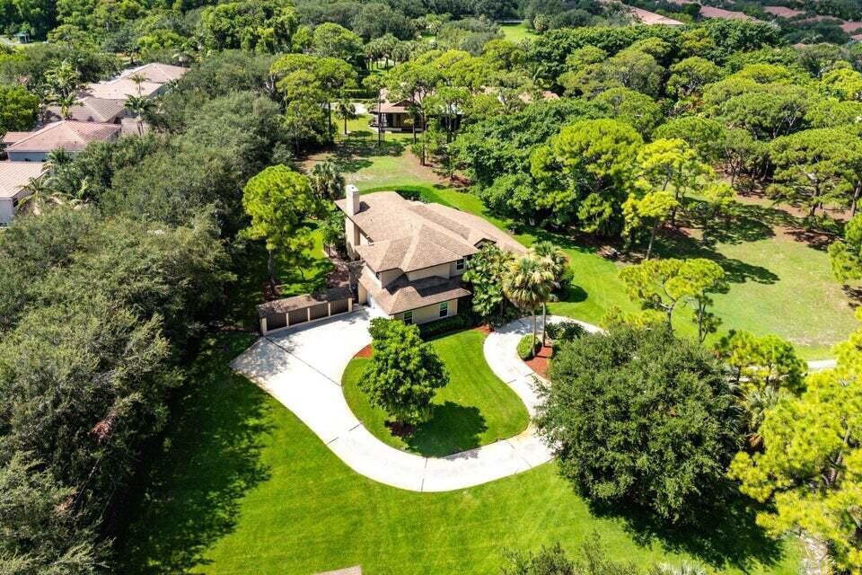 Situated on a rare 3.4-acre residential parcel in Delray Beach, this property offers privacy, space, and flexibility, minutes from the beach and downtown Atlantic Avenue. The single-family residence features 4 bedrooms and 3.5 bathrooms, 3,498 sq ft under air, real wood floors, a wood-burning fireplace, gas stove, dual primary suites (one on the first floor), office, loft, separate laundry room, and locking storage area. Interior systems include a central vacuum, water softener with reverse osmosis filtration, and full hurricane protection. Outdoor amenities include a pool, gazebo, covered patio with French doors, balcony, fruit trees, a fenced residential area, and a boat house with electric and water. No HOA. Future redevelopment potential for up to 17 single-family homes.
