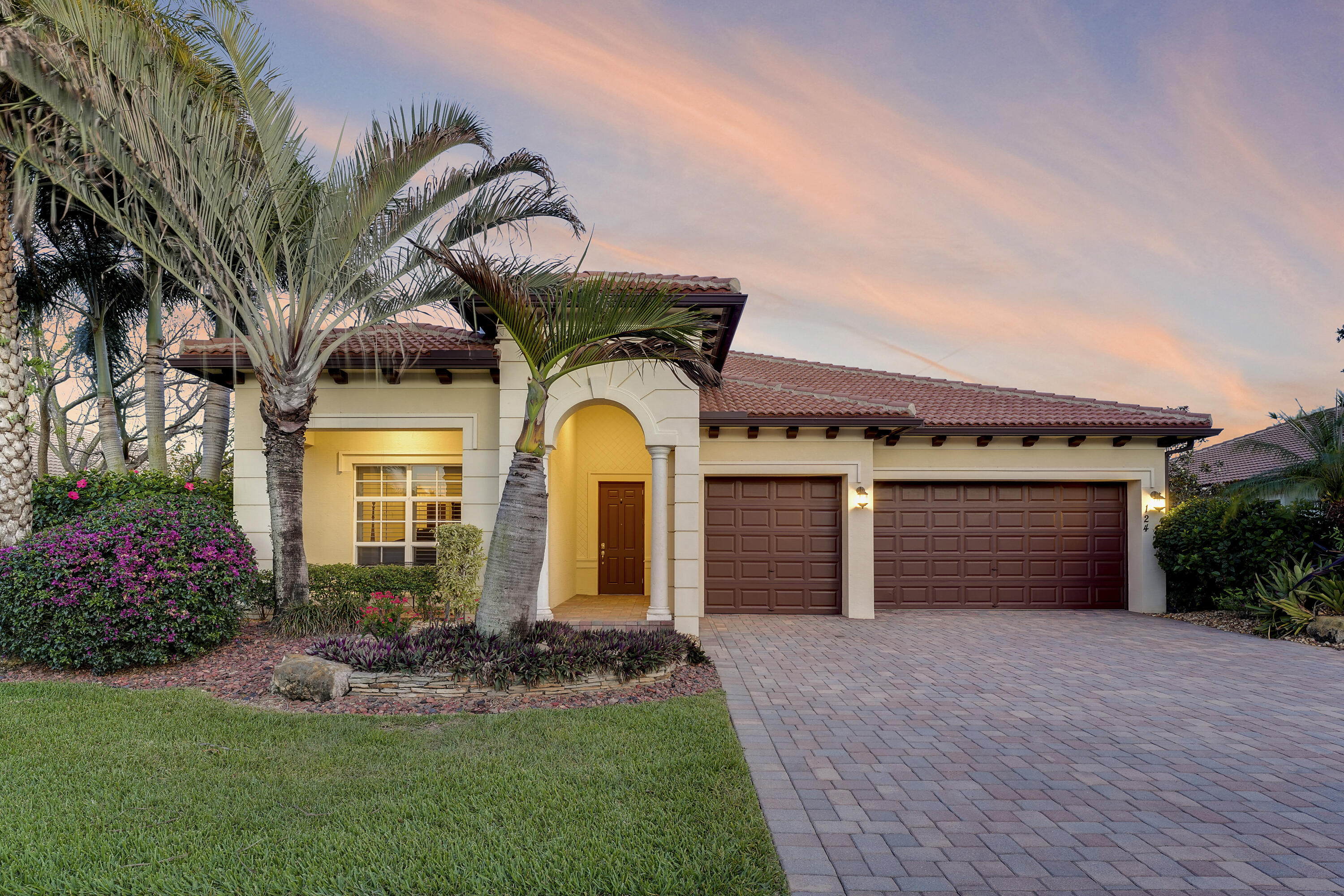 Luxury lakefront living in this beautifully appointed Monterra model located in the gated community of Rialto. Offering just over 2,800 living square feet, this one-story home features 4 bedrooms, 3 bathrooms, and a 3-car garage with a highly desirable 3-way split floor plan. Featuring coffered ceilings, arched entryways, diagonal tile flooring, and elegant trim work throughout. The bright, open layout includes expansive formal living and dining areas, along with a spacious family room and breakfast area—ideal for both everyday living and entertaining. The chef's kitchen is equipped w/SS appliances, double wall ovens, cooktop, granite countertops, and ample cabinetry. Large impact windows and plantation shutters fill the home with natural light while framing serene wide lake views.  All this and a backyard oasis with oversized 20x40 heated saltwater pool, spa and fantastic tiki hut to enjoy the shade. Rialto features resort-style amenities including a clubhouse, fitness center, pool complex with splash pad, basketball courts, and on-site management. HOA covers front and back lawn care. Conveniently located near A-rated schools, beaches, marinas, golf, I-95, the Turnpike, and Palm Beach International Airport. Come experience the Juplife at its finest!