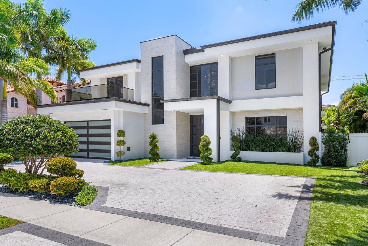 This stunning and light filled artfully designed residence is located in Boca Raton's hottest community, Boca Villas! Walking distance to Mizner Park's world class fine dinning and shopping and close to the famous Boca Raton Hotel and club, and the blue Atlantic ocean. The two story foyer introduces the amazingly beautiful open floor plan. The large modern kitchen, with views of the private back yard, gorgeous pool area with artificial turf and covered summer kitchen, features Sub Zero and Wolf appliances, butlers pantry and large center island and is open to the spacious comfortable and inviting family room. A formal dinning room, large well appointed VIP guest suite, full cabana bath and secondary laundry complete the first floor. A beautiful Ash wood staircase with glass banisters leads to the 2nd floor with large open loft and beautiful hardwood oak floors throughout. The primary bedroom suite with two large walk-in closets, features large glass siders which open to a 25 ft covered balcony finished in brushed shell reef stone, tinted glass banisters and a view of the beautiful pool area and back yard with its artificial turf. The primary bath features a Kohler intelligent toilet, a glass enclosed shower with three shower heads and a beautiful free standing soaking tub. Three additional en suite bedrooms and a large laundry complete the second floor. 
The residence is elevator ready, has a smart Lutron lighting system, motorized shades, sound system speakers throughout, a whole house generator and exterior cameras. A spectacular residence!
