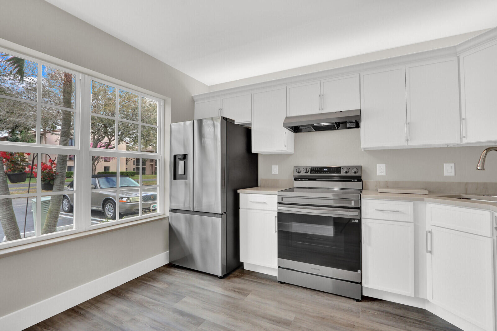 Beautifully renovated and centrally located 3-bedroom, 2.5-bath townhome. This home features a stunning updated kitchen with new stainless-steel appliances, modern cabinetry, quartz countertops, and an undermount sink. The home is light & bright, with a freshly painted interior and wood-look laminate flooring throughout. A new roof was installed in 2023, new hurricane impact windows & doors. New A/C unit. Residents can enjoy the sparkling community pool, scenic walking paths, and a beautiful lake with a fountain at its center. The spacious fenced patio provides the perfect space for entertaining, gardening, or relaxing outdoors. Conveniently located just minutes from parks, the Florida Turnpike, I-95, schools, restaurants, and supermarkets.