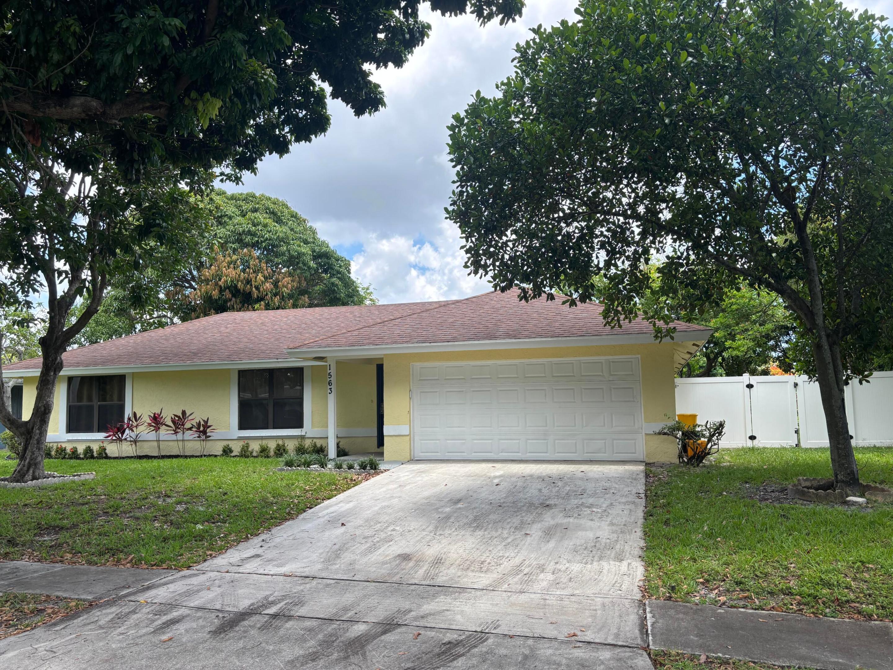 A charming single-story residence offering 1,680 sq. ft. of thoughtfully designed living space. This 4-bedroom, 2-bathroom home features a 2-car garage and complete storm shutter protection for your convenience.  The attractive landscaping is maintenance-free and there is a 6' privacy fence, open patio, and healthy fruit trees for your peaceful enjoyment.  Set in the desirable Westfield at WPB community, this waterfront property is walking distance to the prestigious BAK School of the Arts.