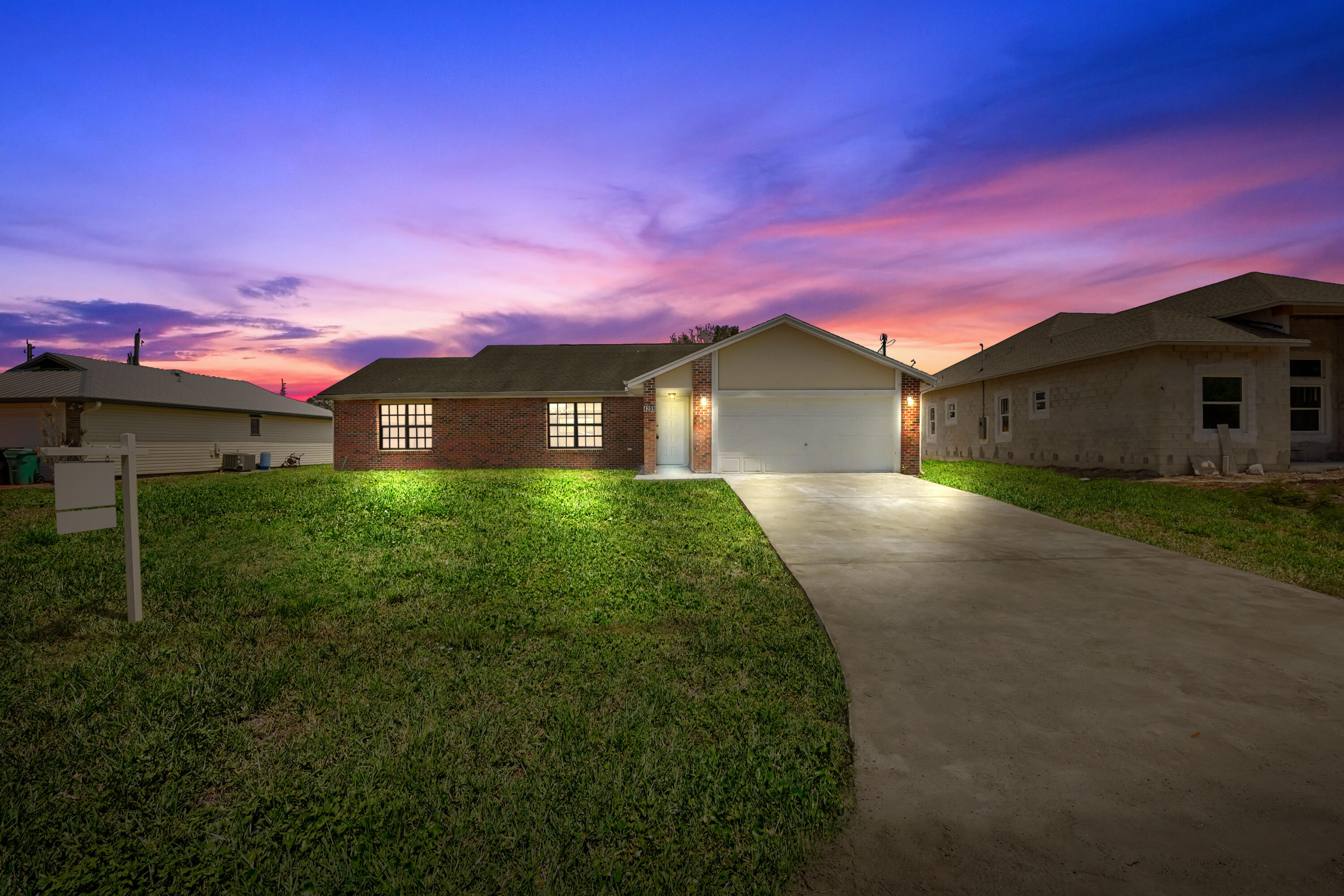 Welcome to this beautifully updated 3-bedroom, 2-bathroom home offering over 1,700 sq ft of move-in ready living space in a convenient Port St. Lucie location. Situated on a spacious lot, the property features a large backyard with plenty of room to relax, entertain, or customize to your liking.  The interior has been fully updated, showcasing a modern design throughout. The kitchen features sleek quartz countertops, updated cabinetry, and a clean, contemporary feel that flows seamlessly into the main living areas. Both bathrooms have been tastefully renovated, and new flooring runs throughout the home, creating a cohesive and stylish look. Additional features full impact windows, along with a 220-volt outlet suitable for electric vehicle charging.  This home offers the perfect blend of comfort, style, and functionality—truly move-in ready. Schedule your showing today!