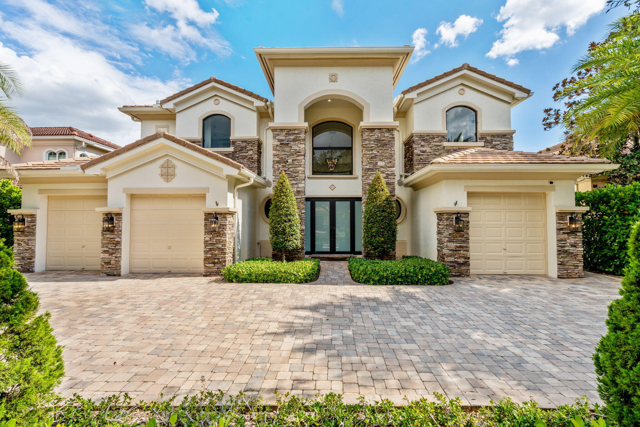 Beyond double entry doors, a remodeled iron staircase frames wide water & preserve views and an 18-ft picture window. 5BR + loft/den, 5BA, 3-car; main-level suite & cabana bath. Impact windows & French doors; remodeled island kitchen; Rain Bird irrigation; A/Cs ~4 yrs (transferable). 27kW whole-house generator w/ 500-gal tank; newer Pentair pool equipment. Large-format porcelain floors, designer lighting & fresh paint. Covered & open patios frame long-lake sunsets and a heated pool/spa. Community offers manned gate w/ app-based guest access, renovated clubhouse & fitness, and new pickleball, tennis & basketball. Close to equestrian venues, shopping/dining, Turnpike/441 & PBI. HOA includes cable & security; Butterfly gate access. Landscaping. Near A+ rated schools, equestrian hubs, beaches.
