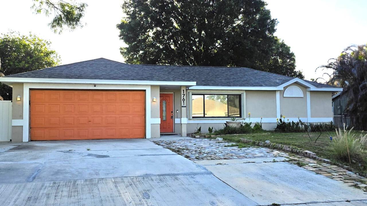 BRAND NEW ROOF! This versatile home in Port St. Lucie, F ready for you to occupy. Offering flexible living spaces and a layout full of character. Featuring 3 bedrooms and 2 baths, plus a converted garage apartment with its own private entrance, bathroom, and kitchenette perfect for guests or extended family.  Step through the foyer with French doors into a spacious tiled great room, which flows into a separate family room accented by wood flooring and a stylish barn door creating defined yet connected living areas. The split floor plan provides added privacy. The kitchen comes equipped with appliances and solid wood cabinetry. Outside, enjoy a fenced backyard with lots of potential to create your perfect relaxing oasis. This home is perfect for multi-generational living options.  Room sizes are approximate and should be independently verified by buyer.  Property may be under audio and video surveillance.